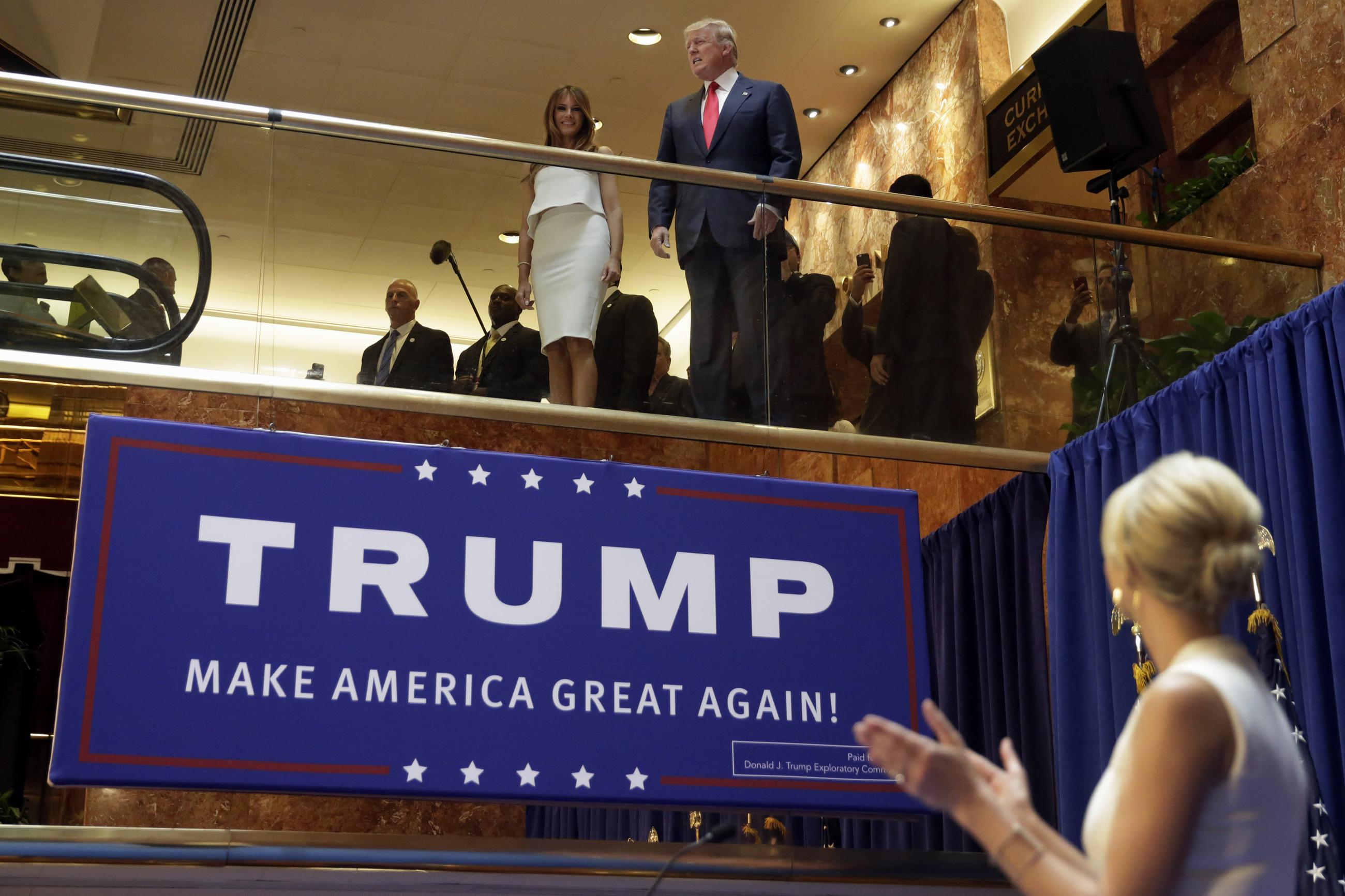 In this June 16, 2015, file photo, Donald Trump, accompanied by Melania Trump at Trump Tower in New York, is applauded by his daughter Ivanka Trump as he's introduced before his announcement that he would run for president. (AP Photo/Richard Drew, File)