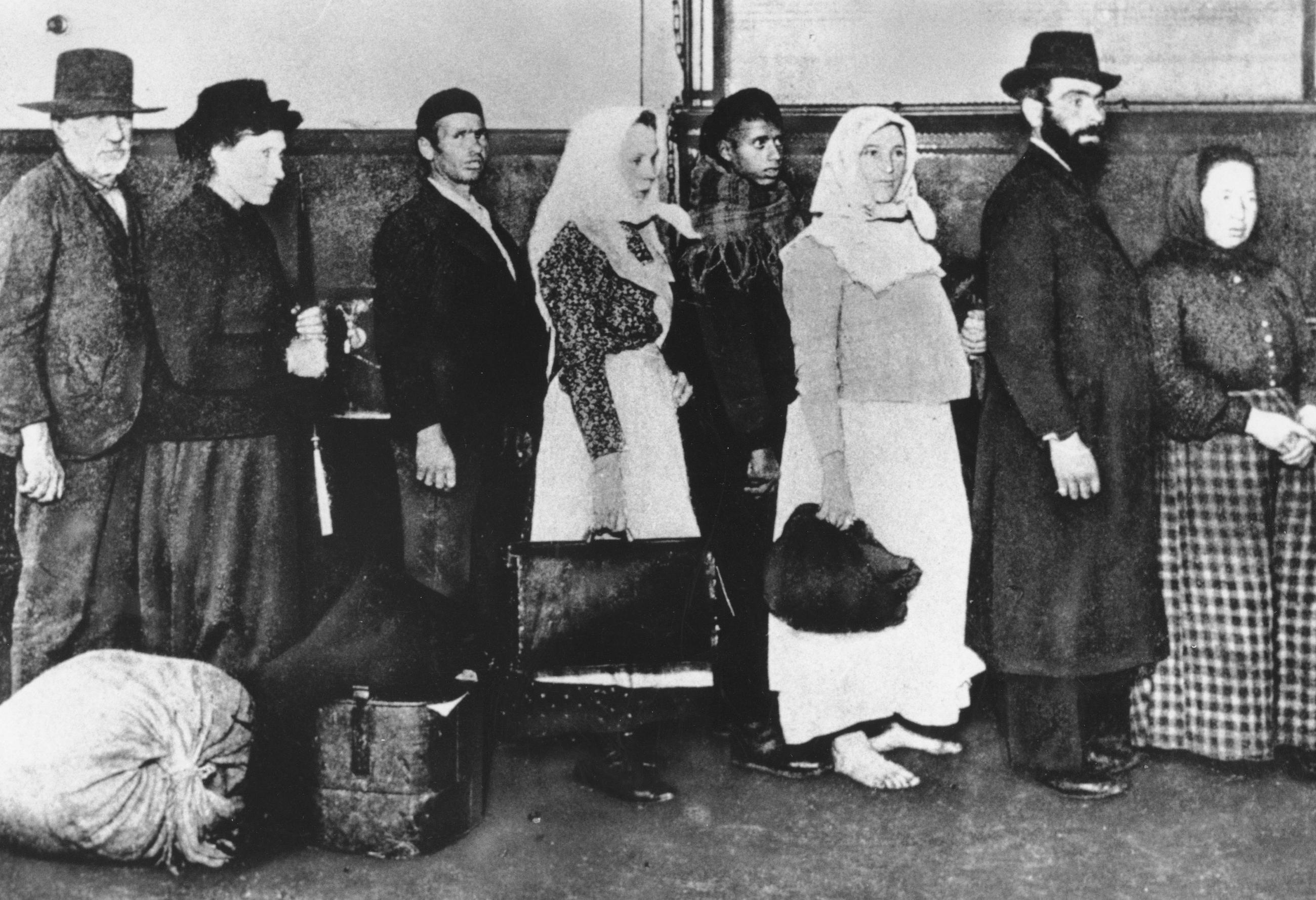 FILE - In this undated file photo, a group of immigrants who arrived at Ellis Island in New York wait in line to begin immigration proceedings.(AP Photo/File)