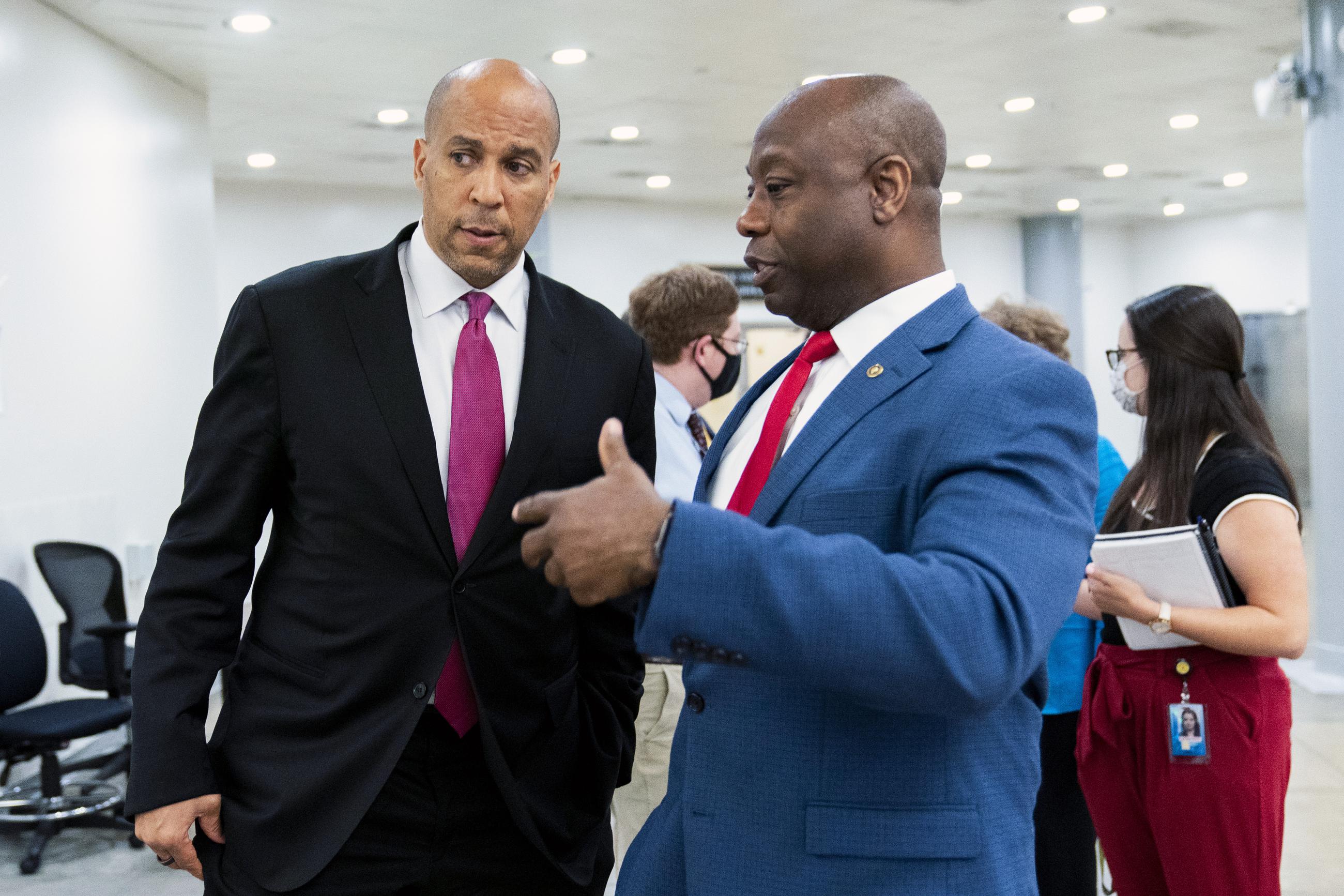 Sen. Tim Scott, right, and Sen. Cory Booker talk as they wait for a Senate subway train on Capitol Hill July 30, 2021. (AP Photo/Manuel Balce Ceneta)