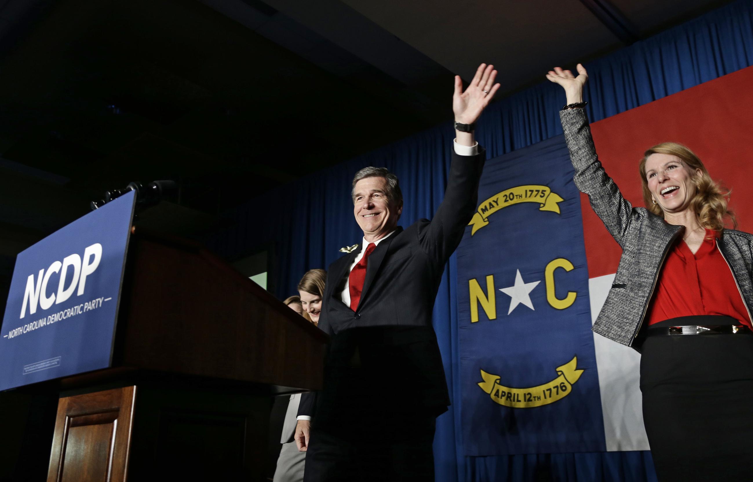 FILE - In this Nov. 9, 2016, file photo, North Carolina Democratic candidate for governor Roy Cooper and his wife Kristin greet supporters during an election night rally in Raleigh, N.C. In closely divided North Carolina, an intense power struggle between Republican lawmakers and Cooper will spill over to voting booths this fall. (AP Photo/Gerry Broome, File)