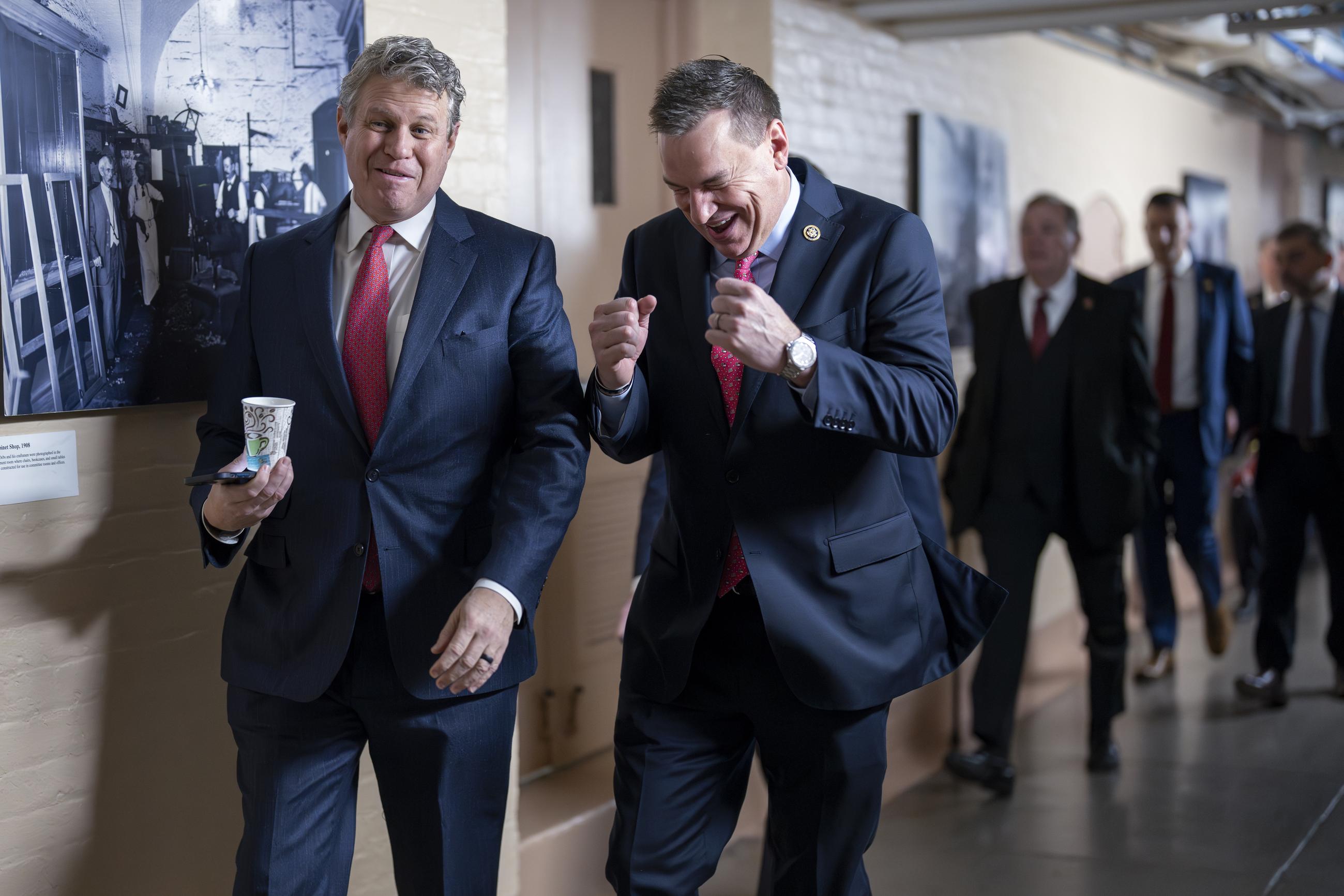 Rep. Bill Huizenga, R-Mich., left, elicits a laugh from Rep. Richard Hudson, R-N.C., as they arrive for a closed-door GOP caucus meeting, at the Capitol in Washington, Wednesday, Feb. 14, 2024. (AP Photo/J. Scott Applewhite)