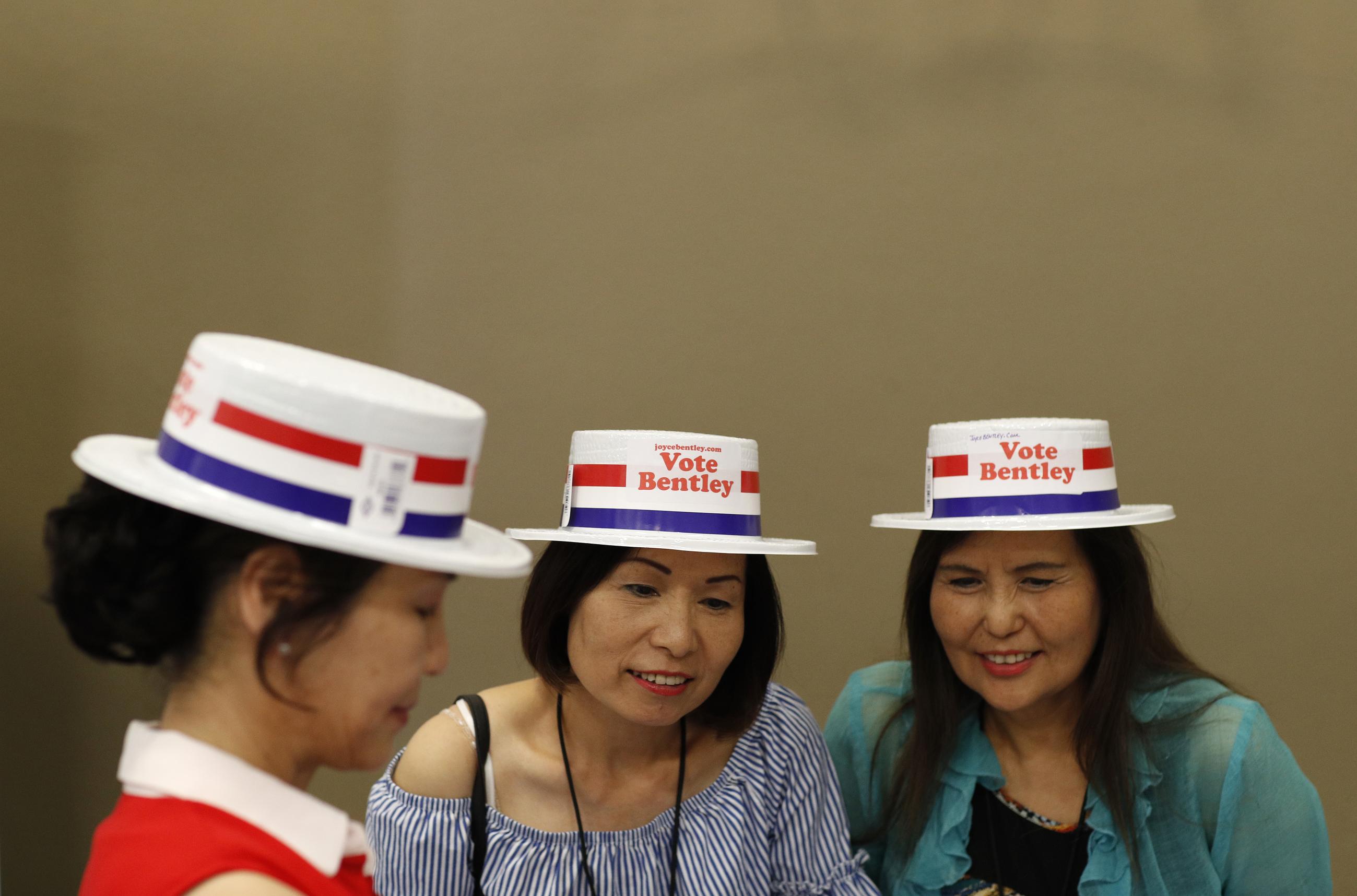 From left, Alice Xie, Kiki Lin and Melody Wong attend an event to meet political candidates, Tuesday, Aug. 28, 2018, in Las Vegas. Candidates running for office in Nevada are making a concerted effort to reach out to Nevada's growing Asian-American and Pacific Islander community with the hope that those voters will swing tight races in the battleground state. (AP Photo/John Locher)