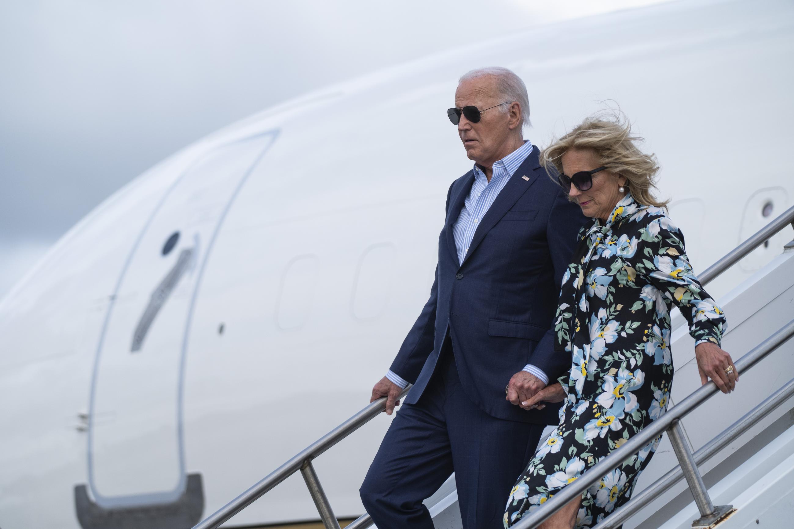 President Joe Biden, left, and first lady Jill Biden arrive at McGuire Air Force Base Saturday in Burlington County, New Jersey. (AP Photo/Evan Vucci)