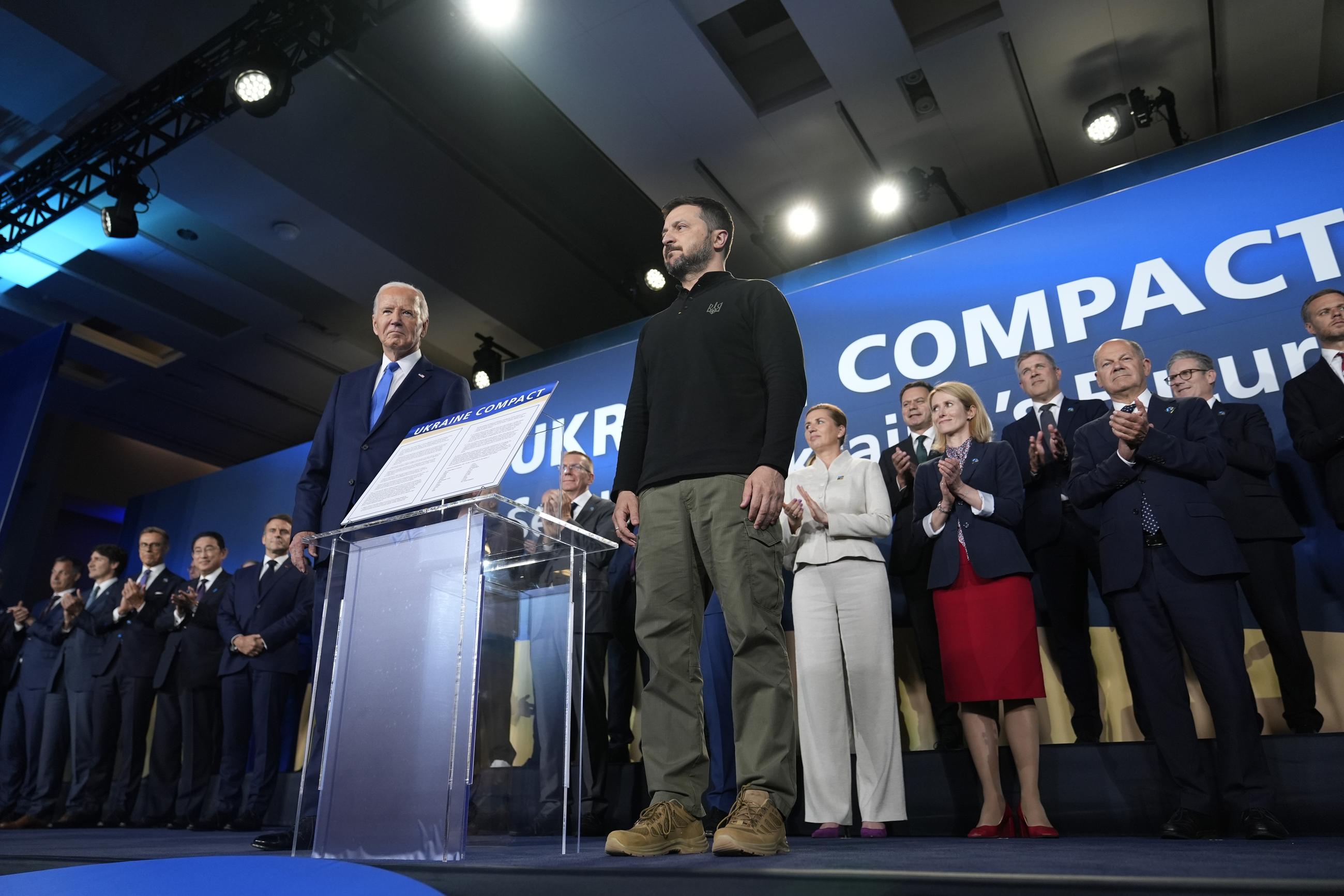 President Joe Biden, left, and President of Ukraine Volodymyr Zelenskyy pose alongside the Ukraine Compact during an event on the sidelines of the NATO Summit in Washington, Thursday, July 11, 2024. Biden launched the Ukraine Compact, signed by 25 countries and the European Union, as part of a commitment to Ukraine's long term security. (AP Photo/Susan Walsh)