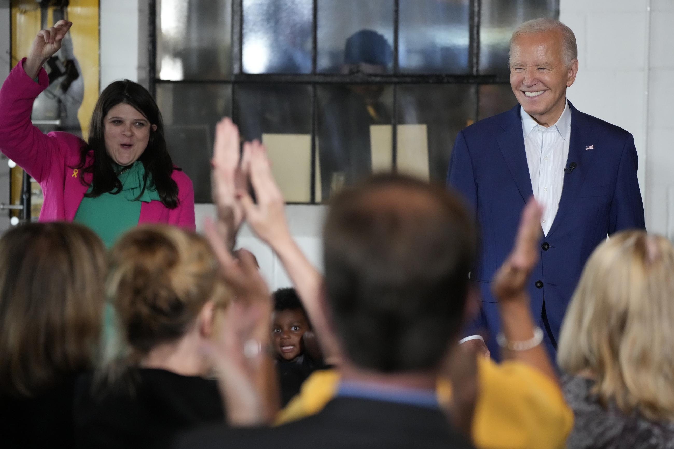 President Biden, right, looks on as Rep. Haley Stevens speaks during a visit to Garage Grill &amp; Fuel Bar during a campaign stop in Northville, Michigan, Friday. (AP Photo/Jacquelyn Martin)