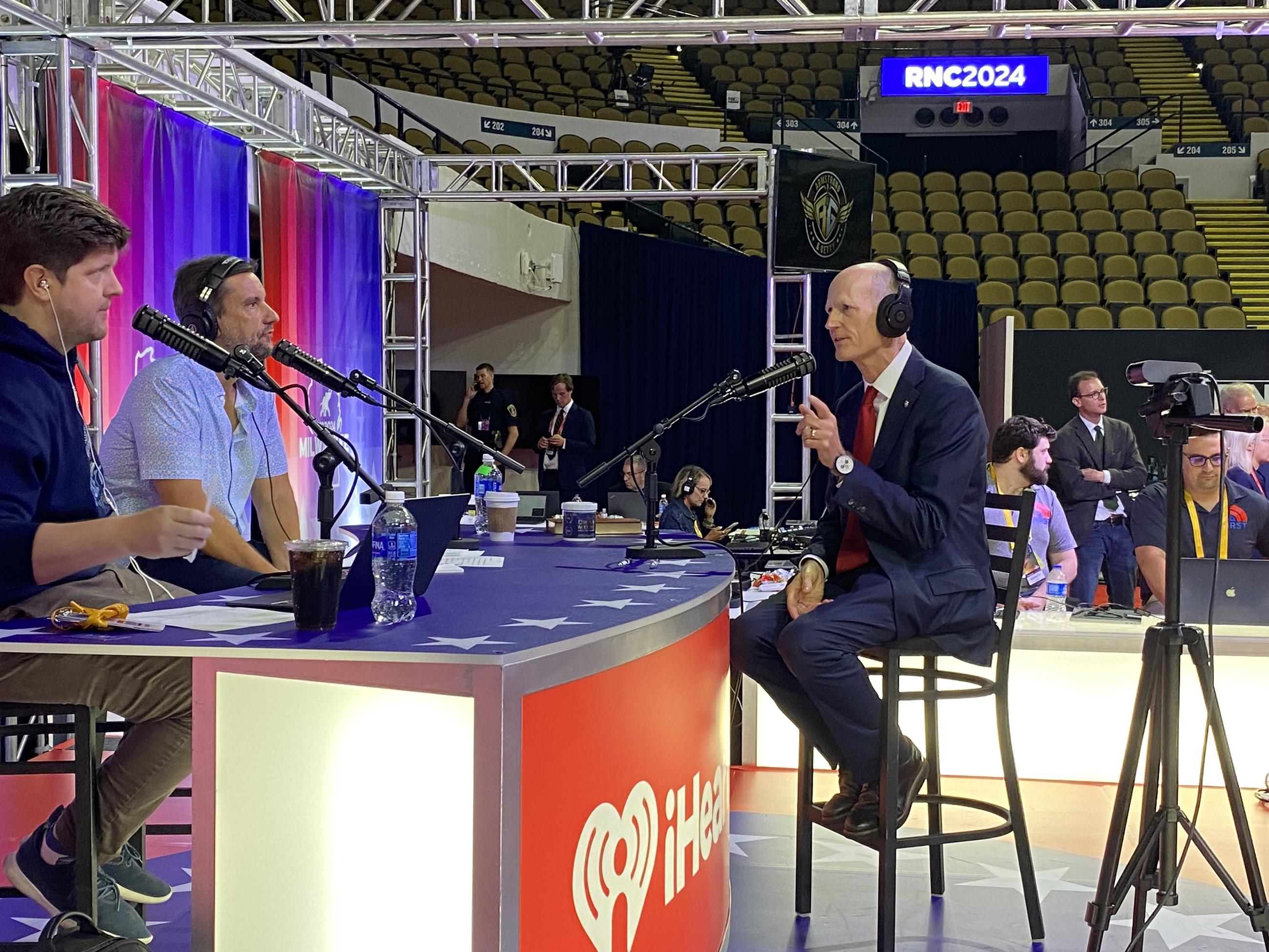 Sen. Rick Scott makes the rounds on radio row at the RNC in Milwaukee Tuesday. (Ledyard King)