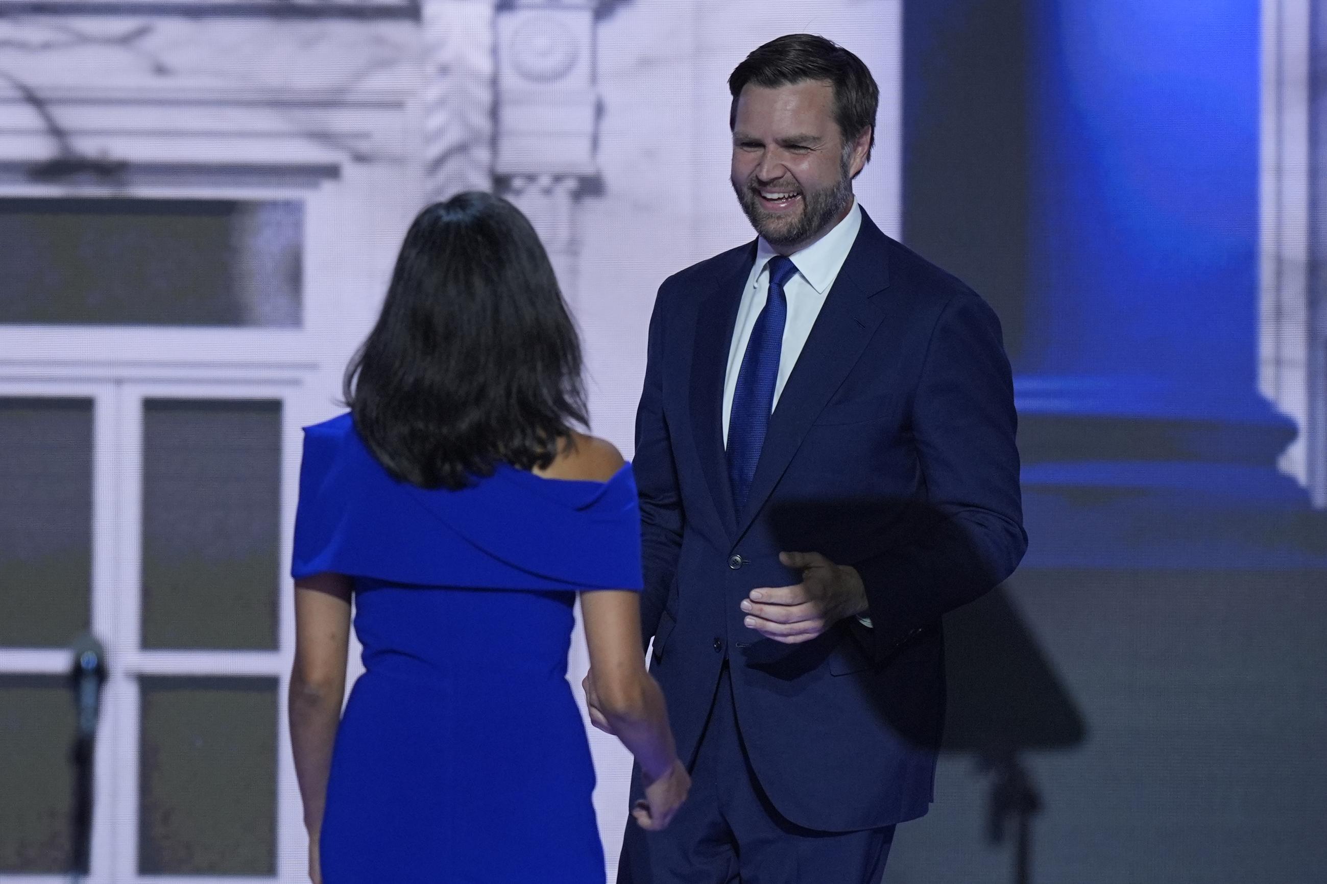 Republican vice presidential candidate J.D. Vance walks over to greet his wife, Usha Chilukuri Vance, during the Republican National Convention in Milwaukee on Wednesday. (AP Photo/J. Scott Applewhite)