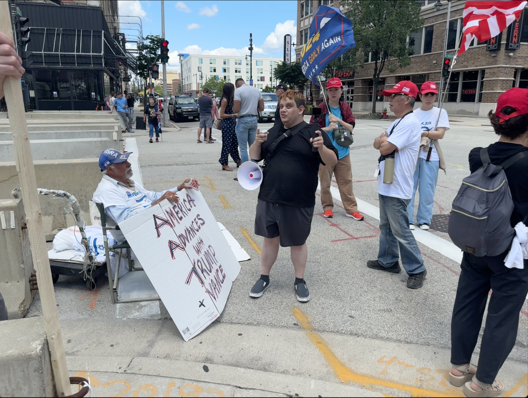 YouTube prankster Michael Picard needles Trump supporter Bob Kunst just outside the Republican National Convention perimeter fence. (Casey Wooten)