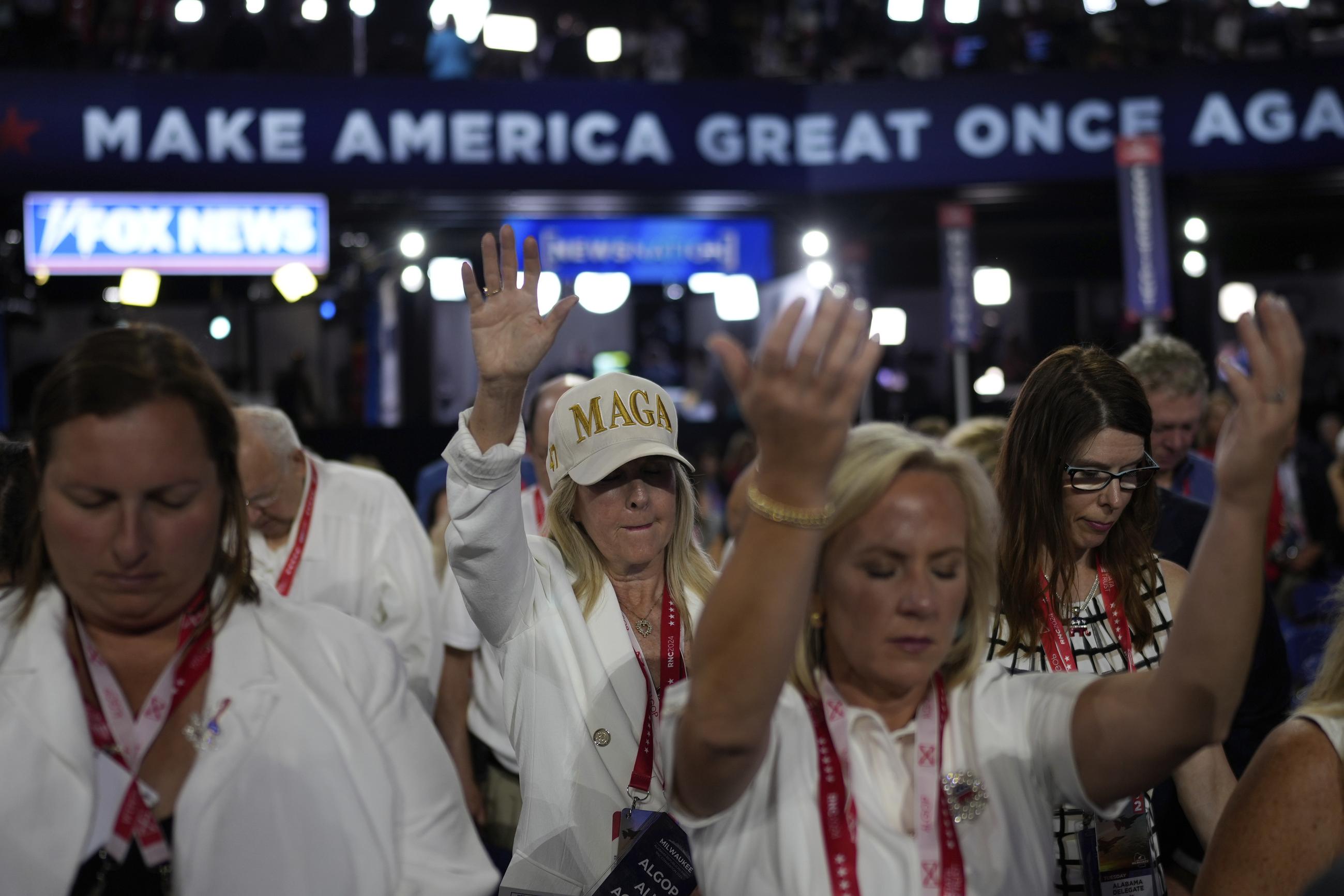 Delegates pray during the Republican National Convention Tuesday in Milwaukee. (AP Photo/Jae C. Hong)
