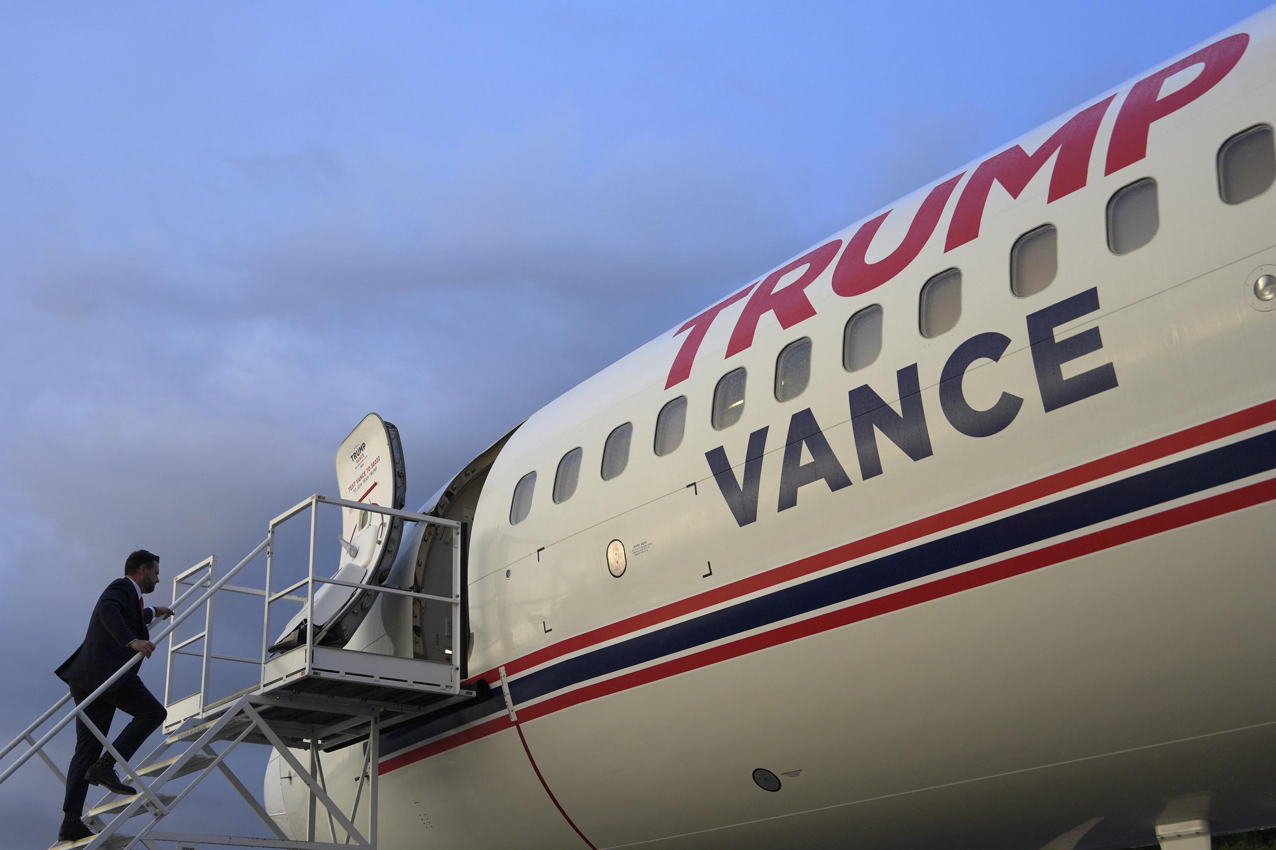 Sen. J.D. Vance boards "Trump Force Two" at Roanoke-Blacksburg Regional Airport after a campaign rally in Roanoke, Va., on Monday. (AP Photo/Julia Nikhinson)