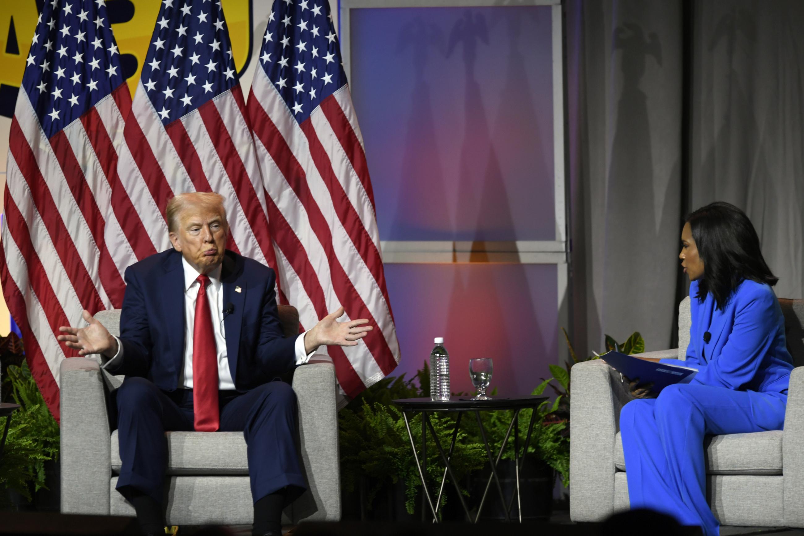 Republican presidential candidate Donald Trump left, participates in a discussion at the National Association of Black Journalists Convention and Career Fair in Chicago, Wednesday, July 31, 2024. On the right is ABC's Rachel Scott. (AP Photo/Paul Beaty)