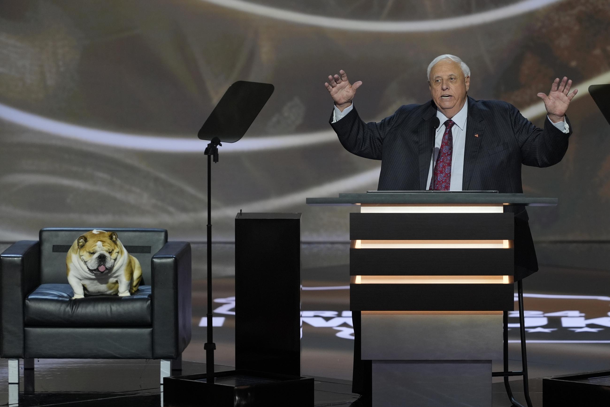 West Virginia Gov. Jim Justice, right, with his dog Babydog, speaks during the Republican National Convention last month in Milwaukee. (AP Photo/J. Scott Applewhite)