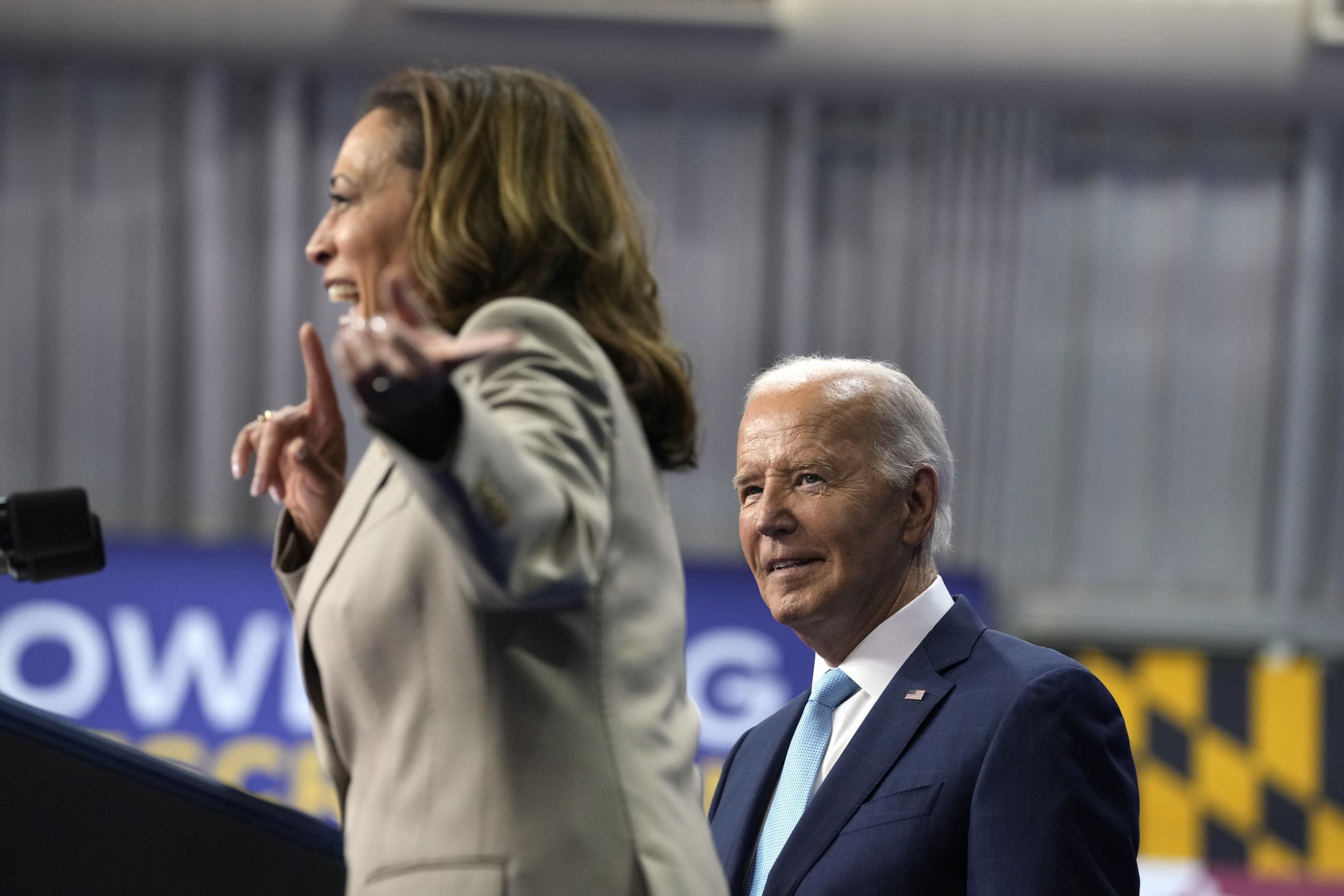 President Biden listens as Vice President Kamala Harris speaks about the administration's efforts to lower costs during an event at Prince George's Community College in Largo, Md., on Thursday. (AP Photo/Susan Walsh)