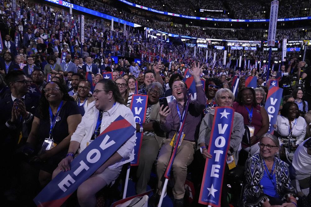 Delegates watch as former President Obama speaks during the Democratic National Convention on Tuesday. (AP Photo/Brynn Anderson)
