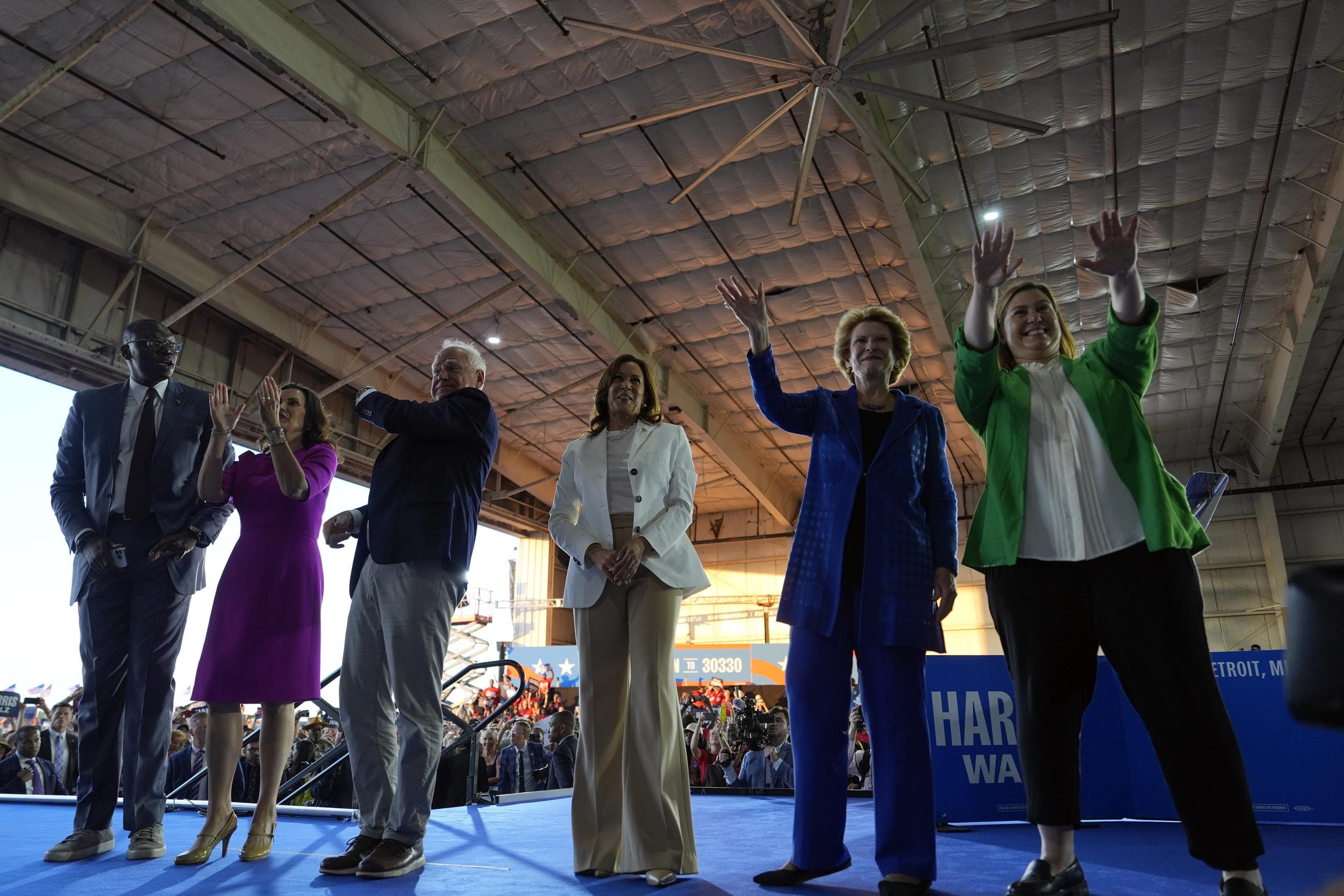 (From left) Michigan Lt. Gov. Garlin Gilchrist, Michigan Gov. Gretchen Whitmer, Minnesota Gov. Tim Walz, Vice President Kamala Harris, Sen. Debbie Stabenow of Michigan, and Rep. Elissa Slotkin of Michigan at a campaign rally in Romulus, Mich., on Aug. 7 (AP Photo/Julia Nikhinson)