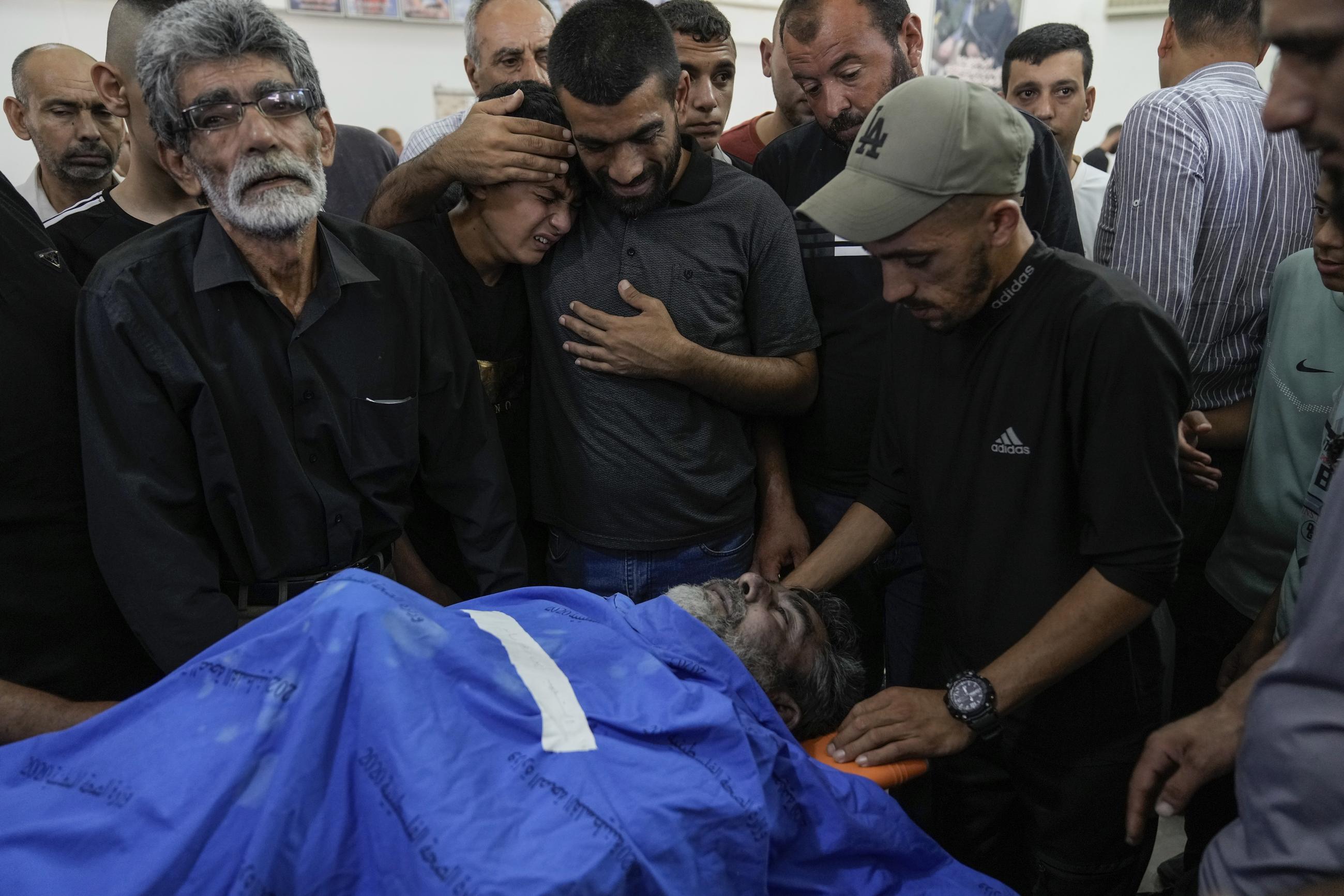 Mourners gather around the body of Ayman Abed, 58, during his funeral in the West Bank village of Kafr Dan near Jenin Monday. (AP Photo/Majdi Mohammed)