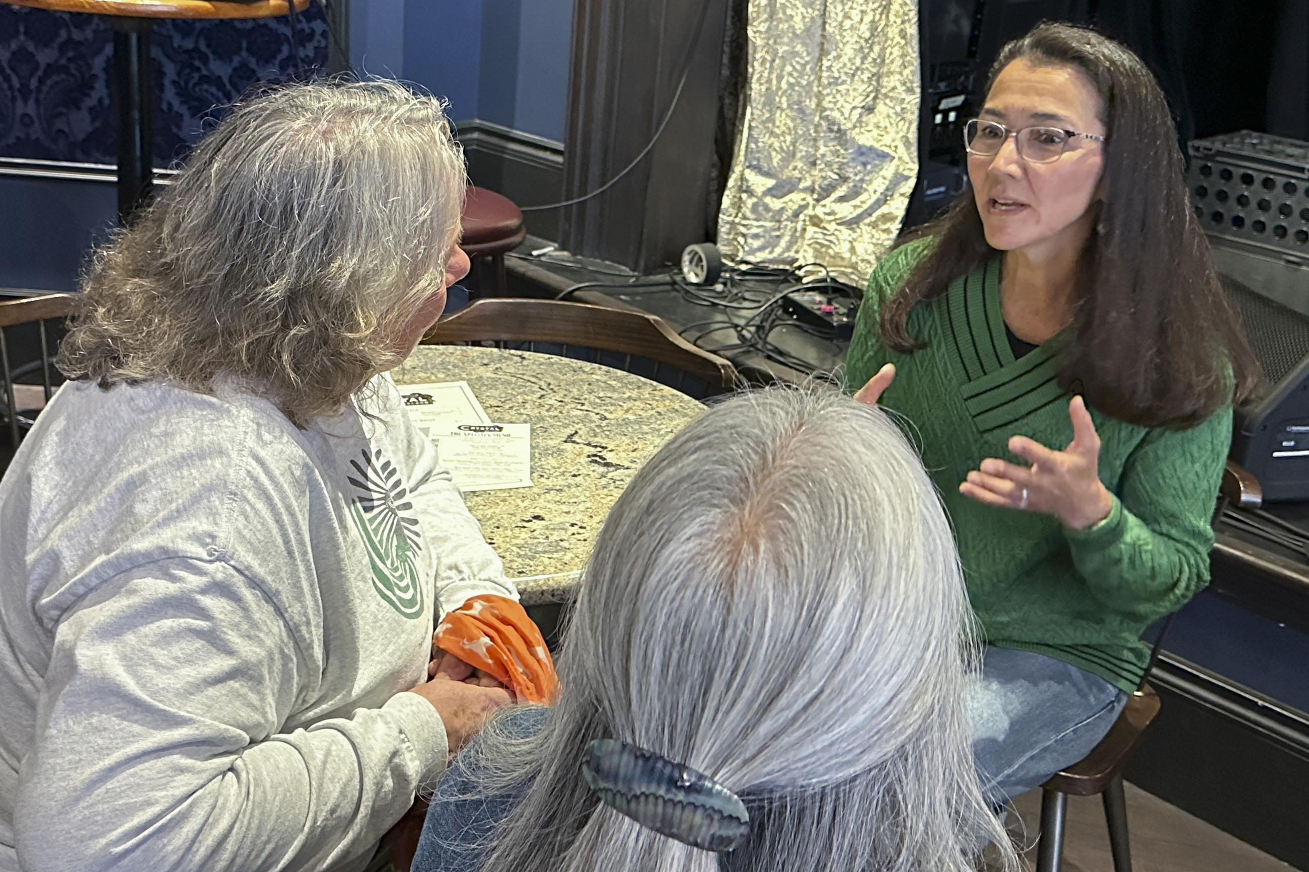 Alaska U.S. Rep. Mary Peltola, right, talks with people during a campaign event in Juneau, Alaska on Saturday, Aug. 3, 2024. (AP Photo/Becky Bohrer)