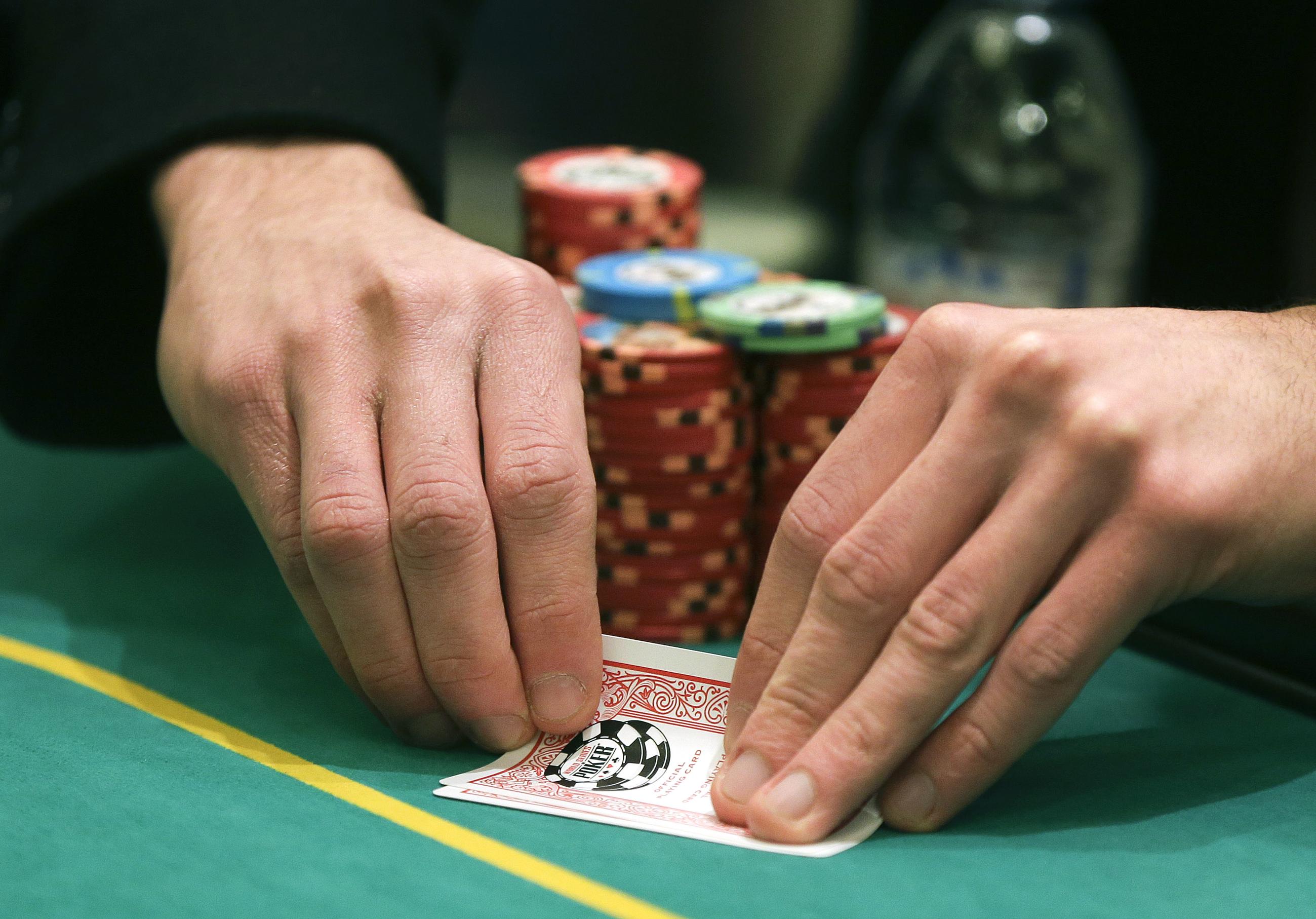 A player checks his hand during a game of Texas Hold 'em. (AP Photo/Julie Jacobson)