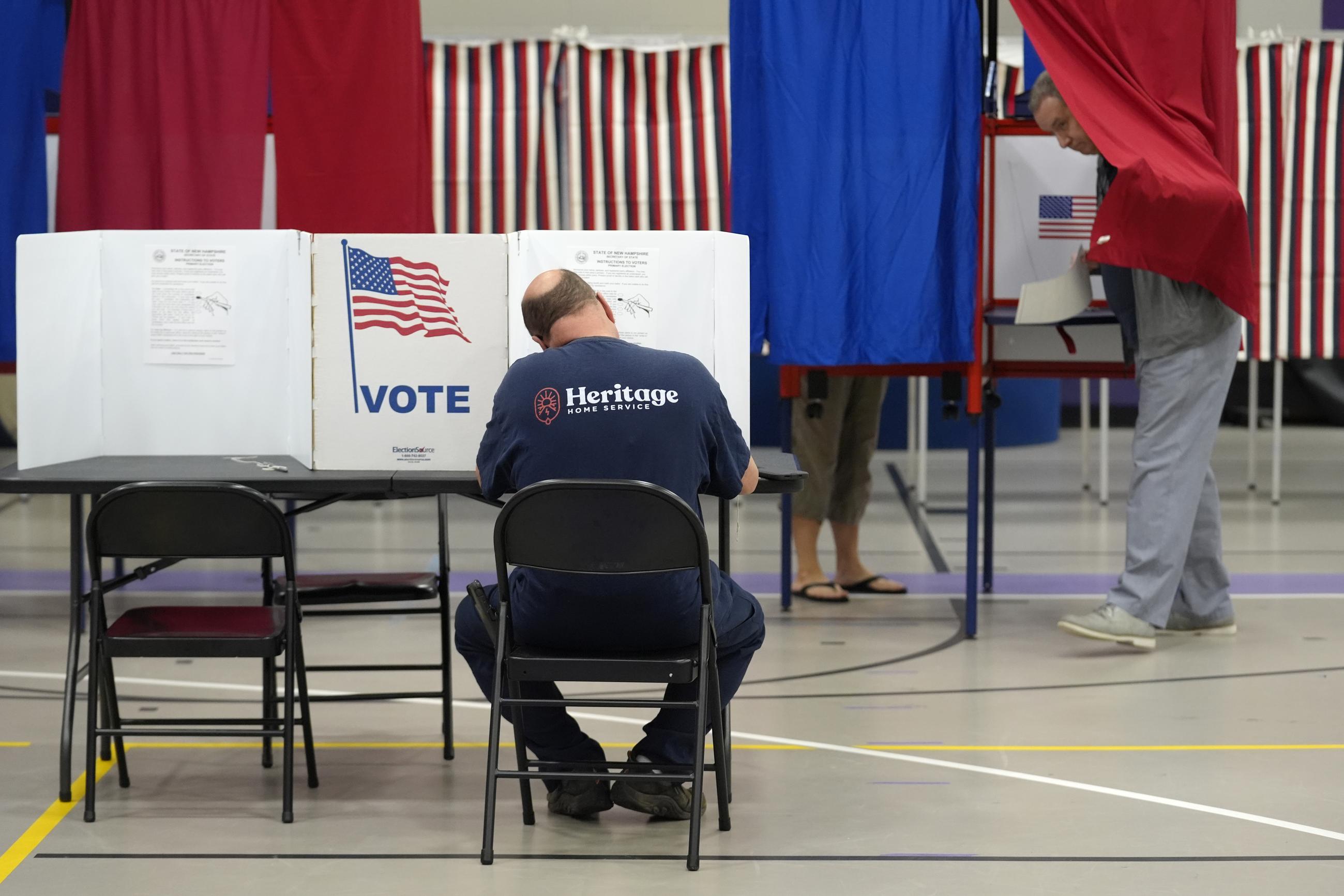 Voters fill out ballots in a primary election to pick candidates for governor, the U.S. House, and the state Legislature in Nashua, N.H., on Sept. 10, 2024. (AP Photo/Steven Senne)