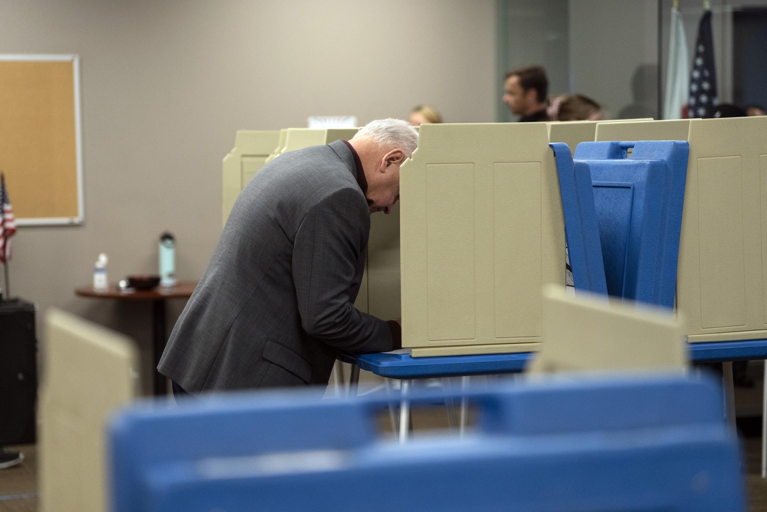 Democratic vice presidential nominee Minnesota Gov. Tim Walz votes early in a voting booth at the Ramsey County Elections office in St. Paul, Minn., Wednesday, Oct. 23, 2024. (Renée Jones Schneider/Star Tribune via AP, Pool)