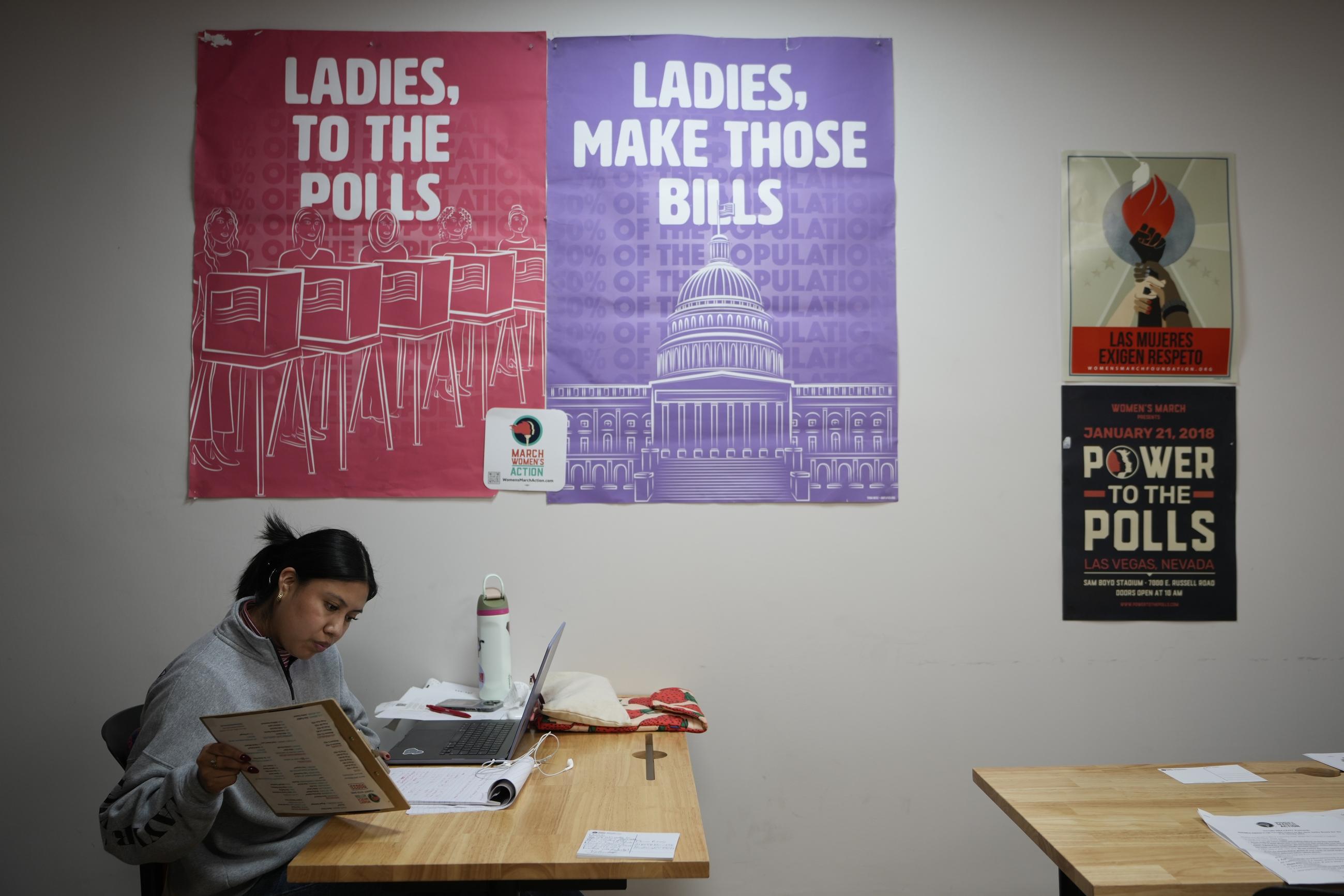 Mirian Palacios, volunteer and campaign manager, joins a group at a phone bank encouraging voters to vote for Vice President Kamala Harris. (AP Photo/Damian Dovarganes)