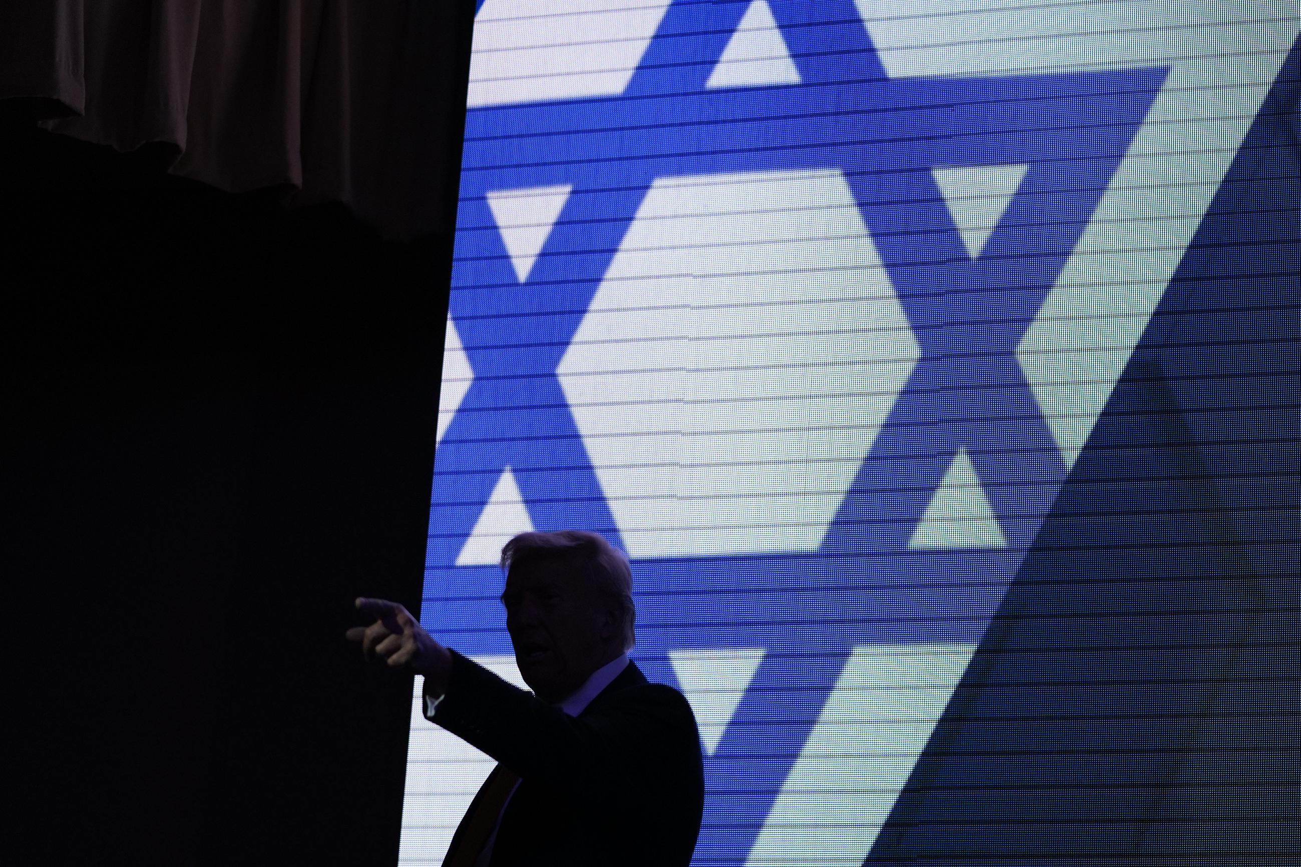 Donald Trump acknowledges the crowd as he exits the stage after speaking at the Israeli American Council National Summit in Washington on Sept. 19. (AP Photo/Evan Vucci)