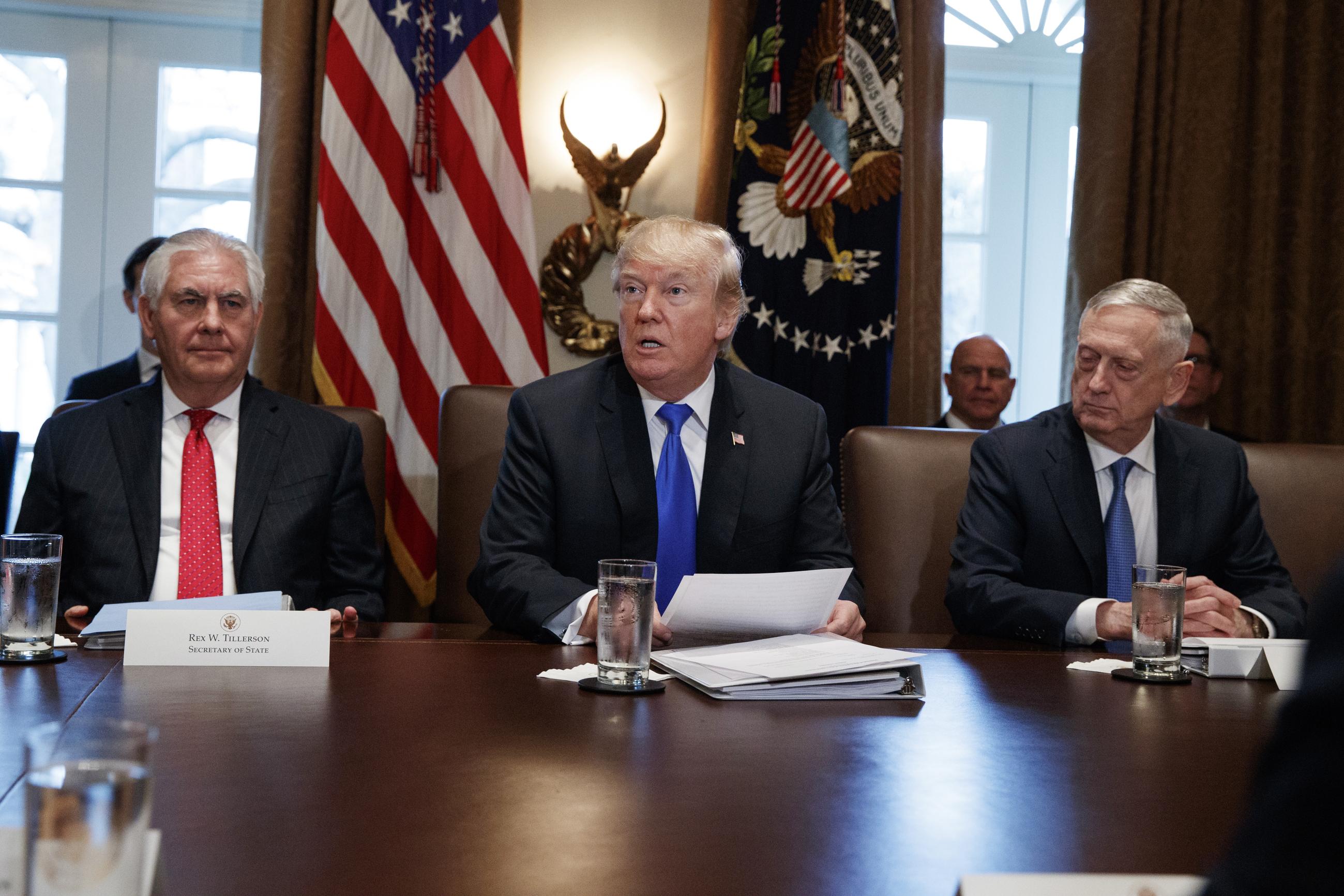 Then-Secretary of State Rex Tillerson and then-Defense Secretary Jim Mattis listen as President Trump speaks during a Cabinet meeting at the White House in 2017. (AP Photo/Evan Vucci)