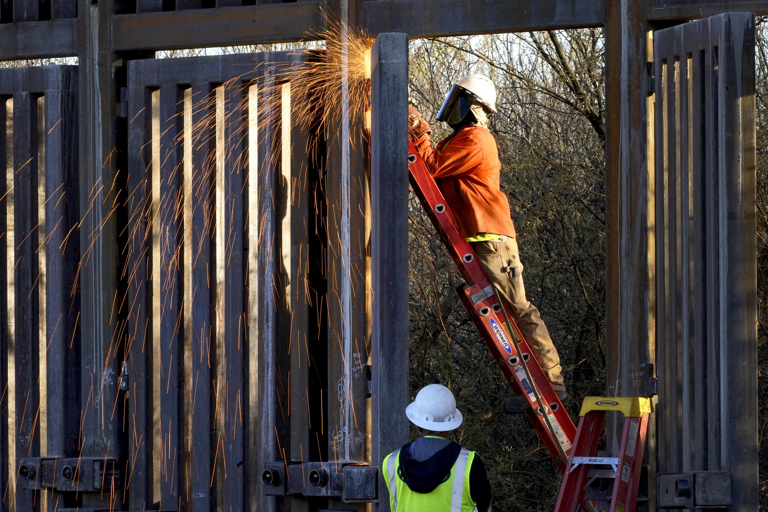 Crews construct a section of border wall in Douglas, Ariz., in 2020. (AP Photo/Matt York)