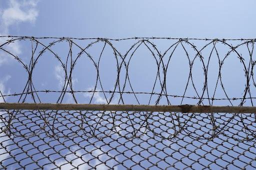 Barbed and razor wires are installed on the fence at the Port Isabel Detention Center in Los Fresnos, Texas, on June 10. (Veronica Gabriela Cardenas/Pool Photo via AP)