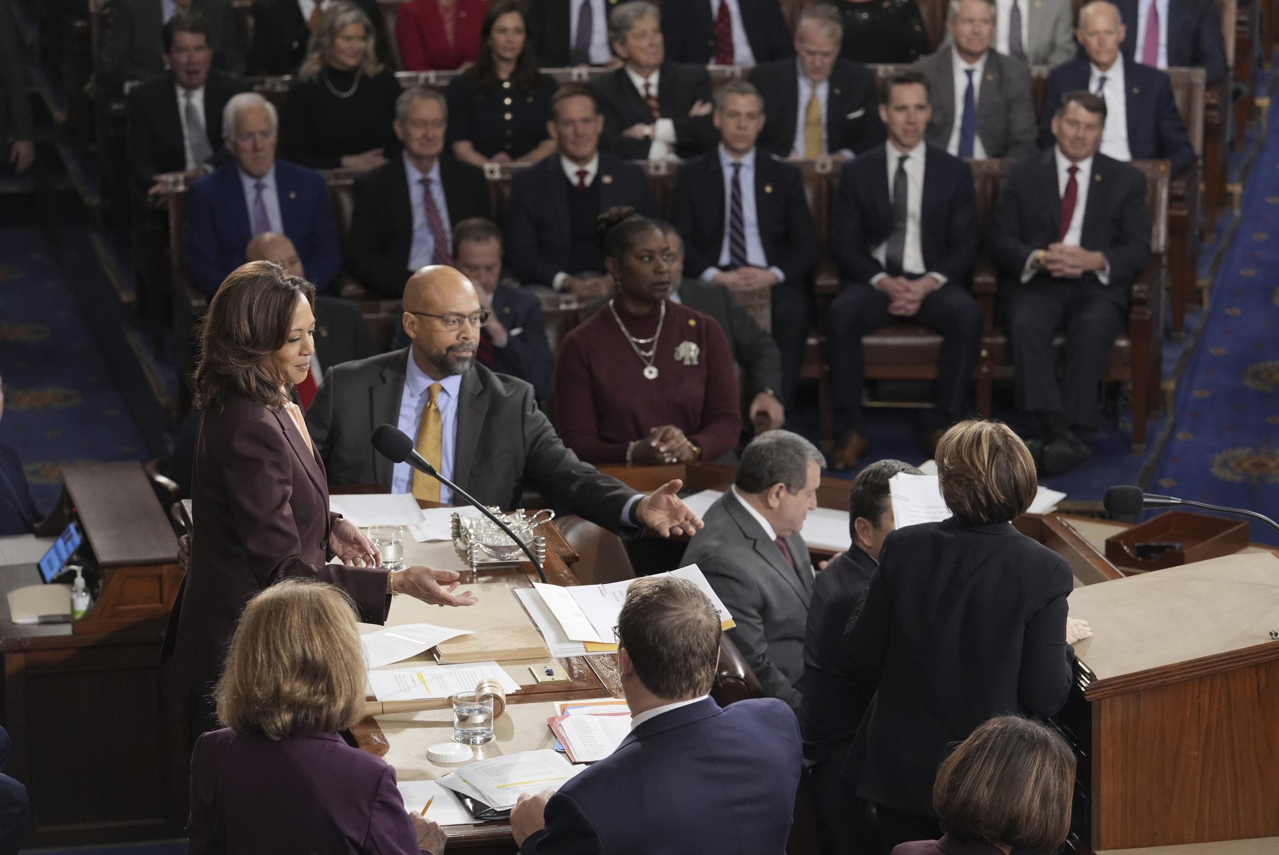 Vice President Kamala Harris is handed a certification as the joint session of Congress convenes to confirm the Electoral College votes, affirming President-elect Donald Trump's victory in the presidential election, Monday, Jan. 6, 2025, at the U.S. Capitol in Washington. (AP Photo/J. Scott Applewhite)