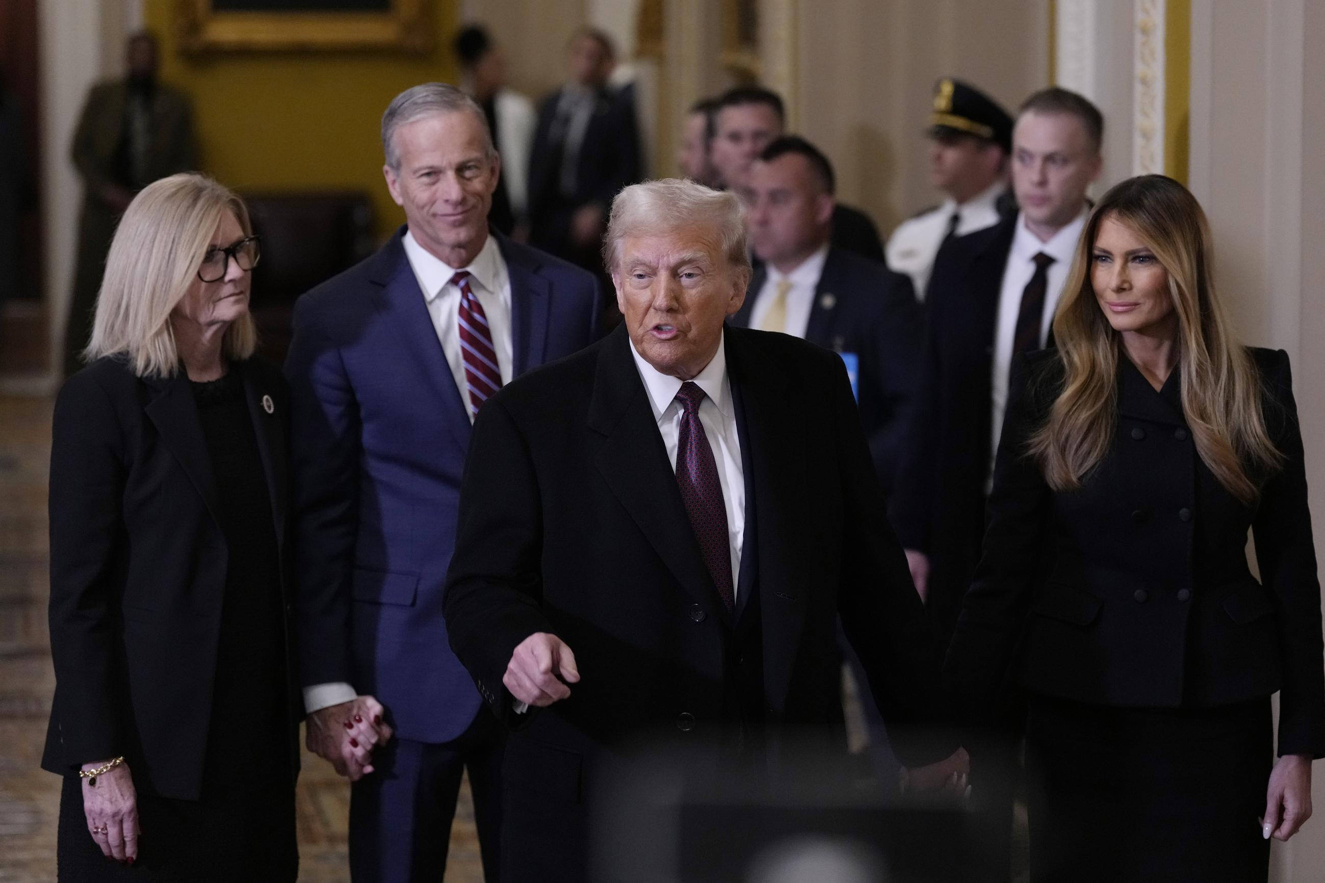 President-elect Trump and his wife Melania, walk with Senate Majority Leader John Thune and his wife, Kimberley, to meet with Senate Republicans at the Capitol Wednesday. (AP Photo/Steve Helber)