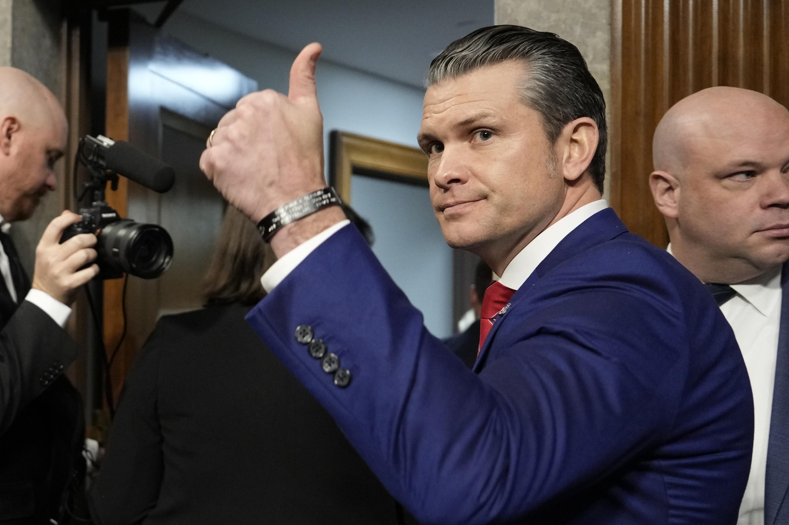 Pete Hegseth, President-elect Trump's choice to be Defense secretary, gives a thumbs-up at the completion of his confirmation hearing before the Senate Armed Services Committee at the Capitol Tuesday. (AP Photo/Ben Curtis)