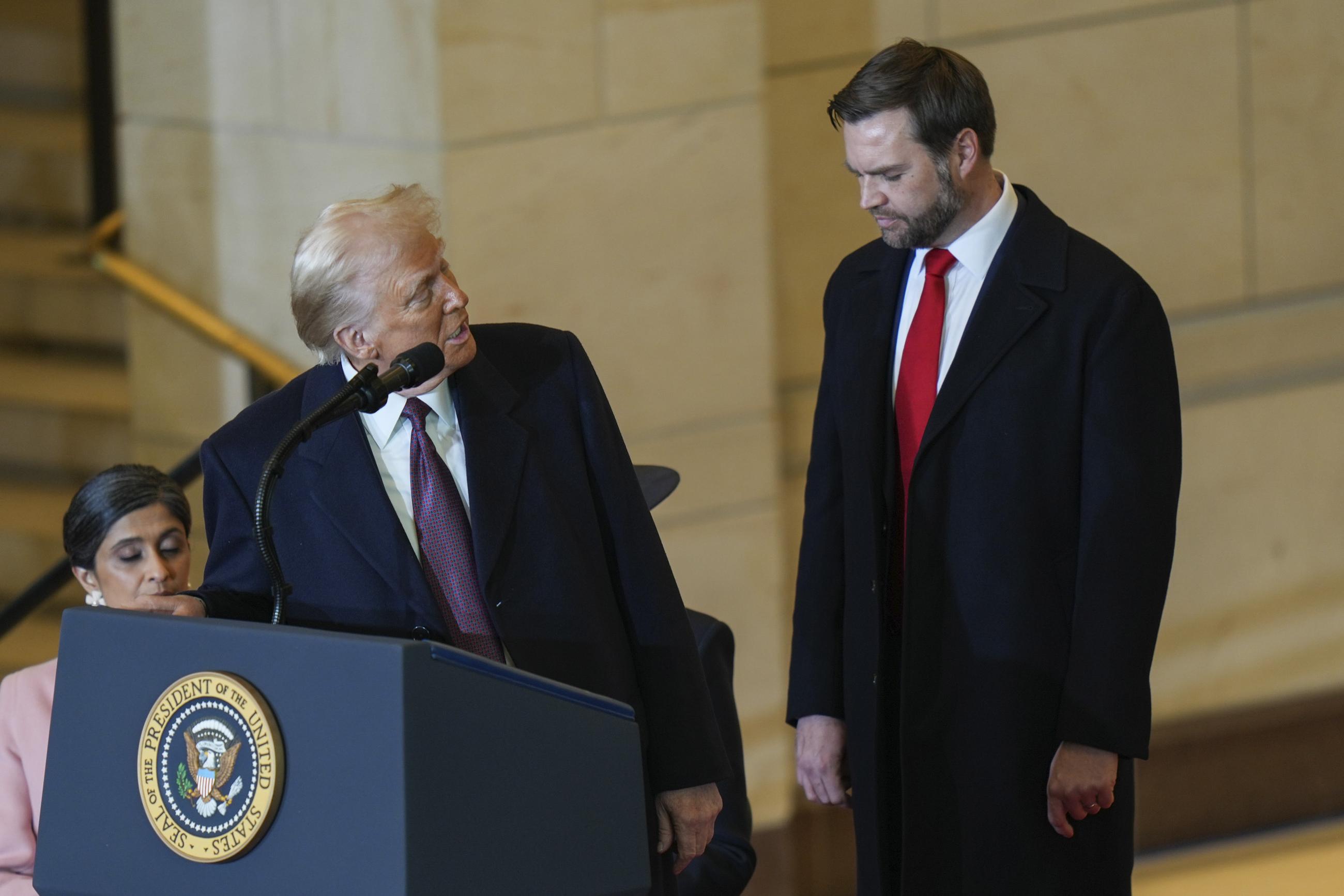 President Trump speaks as Vice President J.D. Vance listens in Emancipation Hall after the 60th Presidential Inauguration in the Rotunda of the U.S. Capitol Monday. (Angelina Katsanis/Pool Photo Photo via AP)
