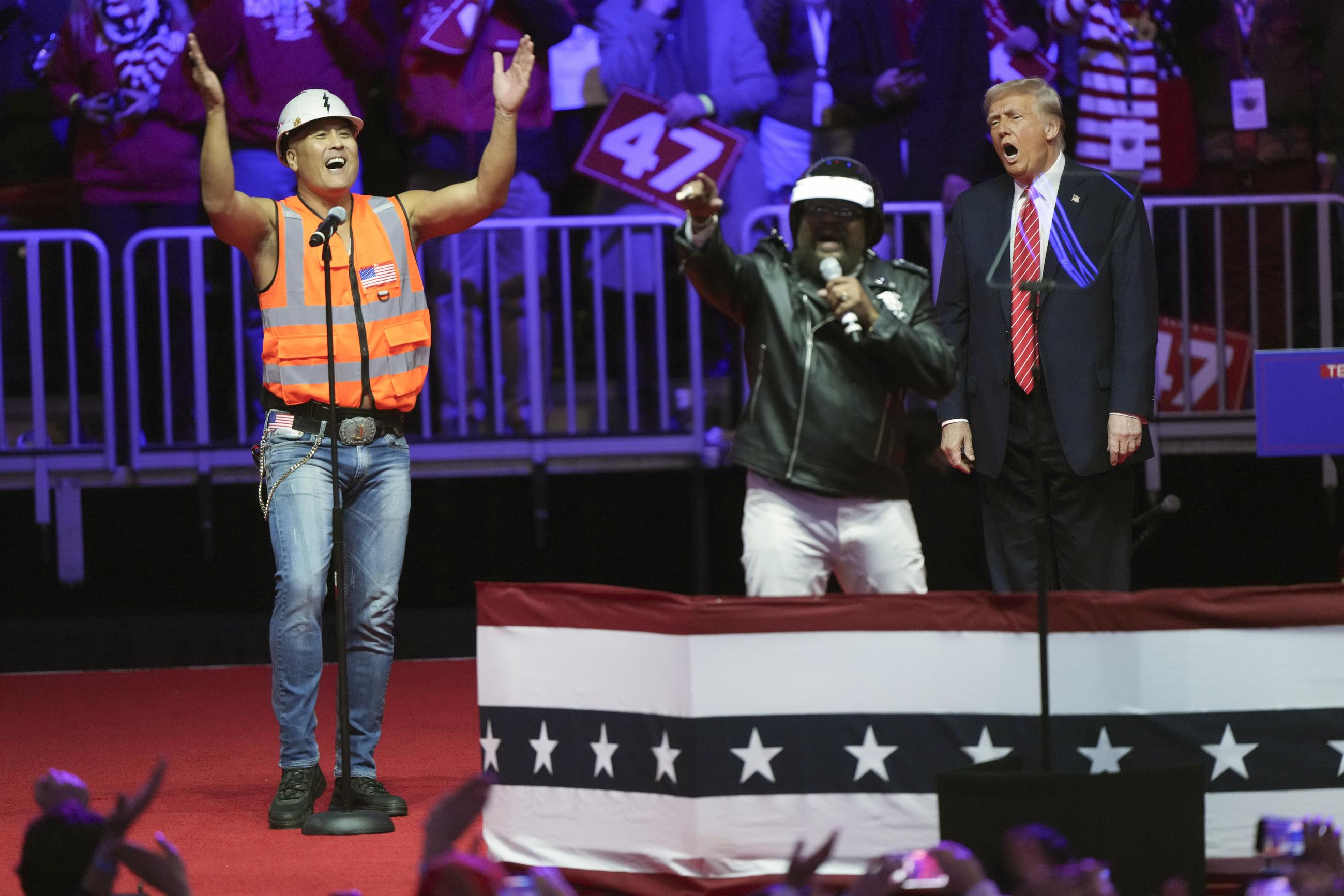 The Village People perform as Donald Trump looks on at a pre-inauguration rally in Washington Sunday.