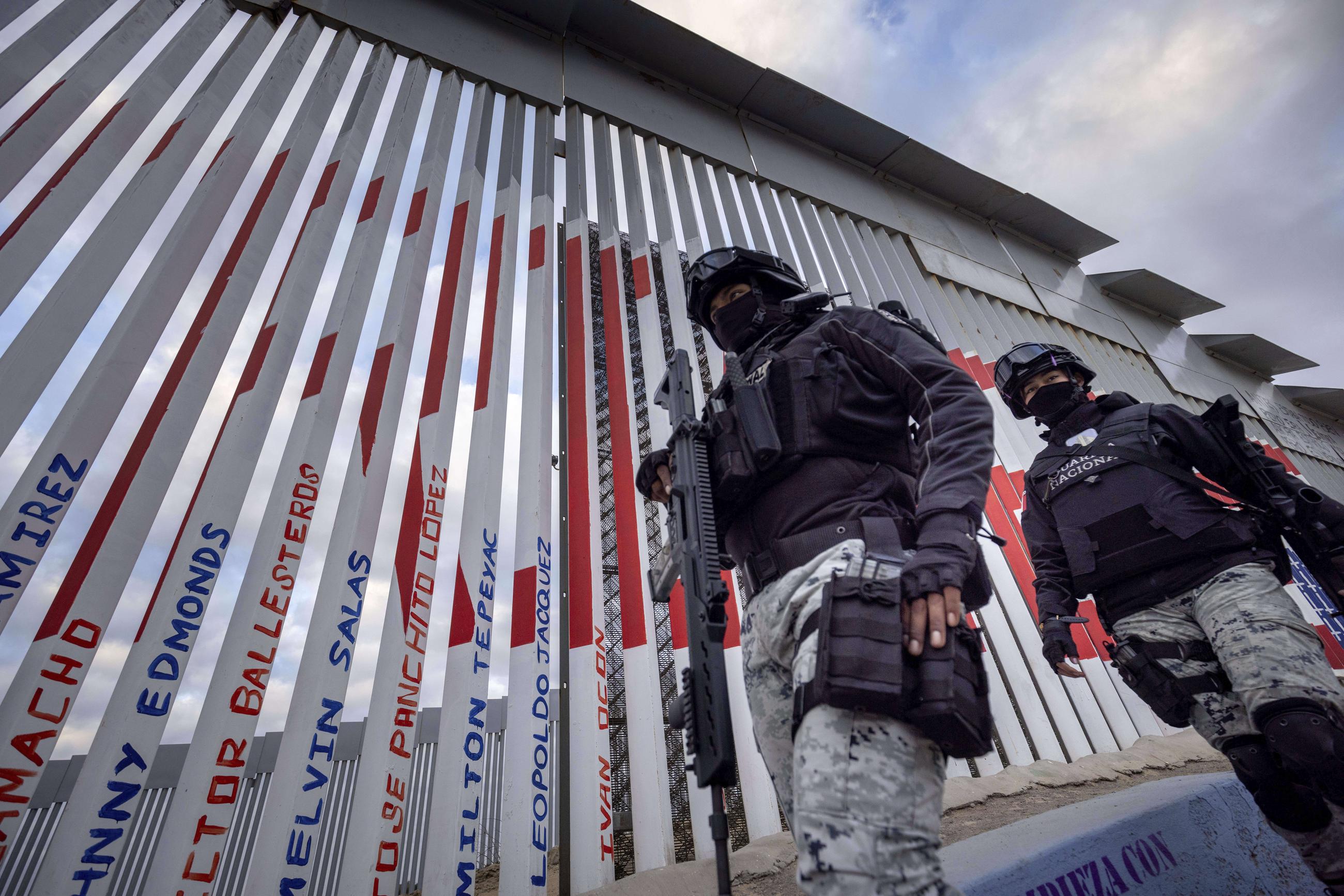 Members of the Mexican National Guard patrol next to the U.S.-Mexico border wall Saturday, Jan. 25, 2025, in Tijuana, Mexico. (AP Photo/Ethan Swope)
