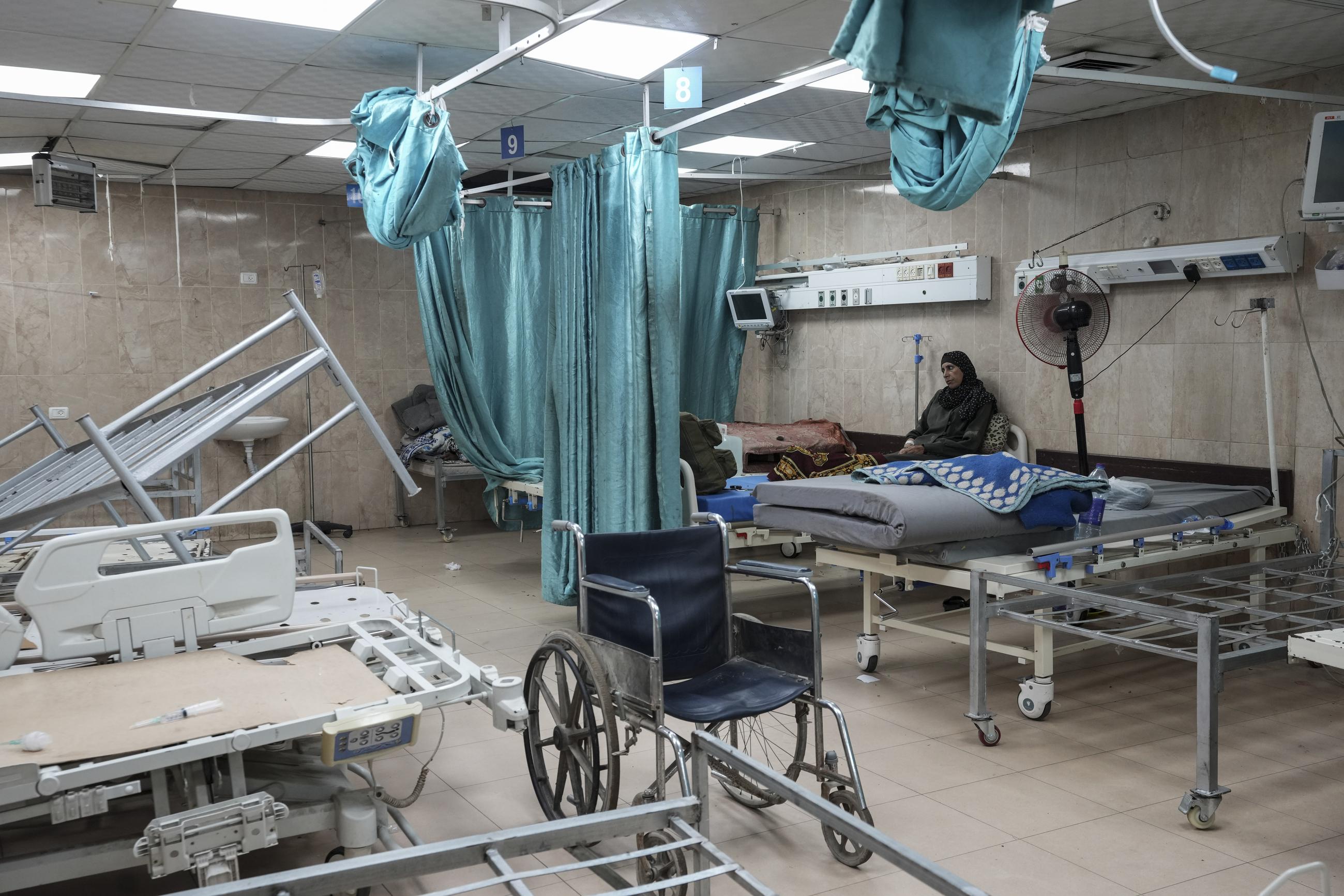 A woman sits on a bed in a room of the Al-Aqsa Martyrs hospital in Deir al Balah, Gaza Strip, in August 2024. (AP Photo/Abdel Kareem Hana, File)