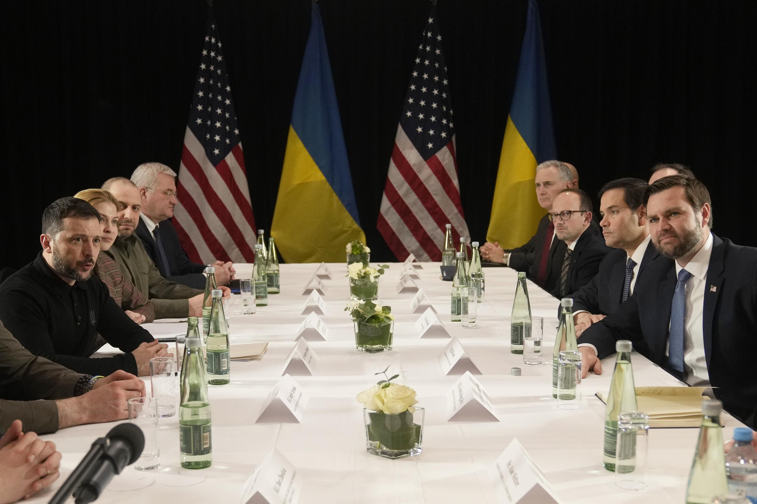 Ukrainian President Volodymyr Zelensky, left, and United States Vice President J.D. Vance, right, pose during a meeting on the sidelines of the Munich Security Conference in Munich, Germany, Friday. (AP Photo/Matthias Schrader)