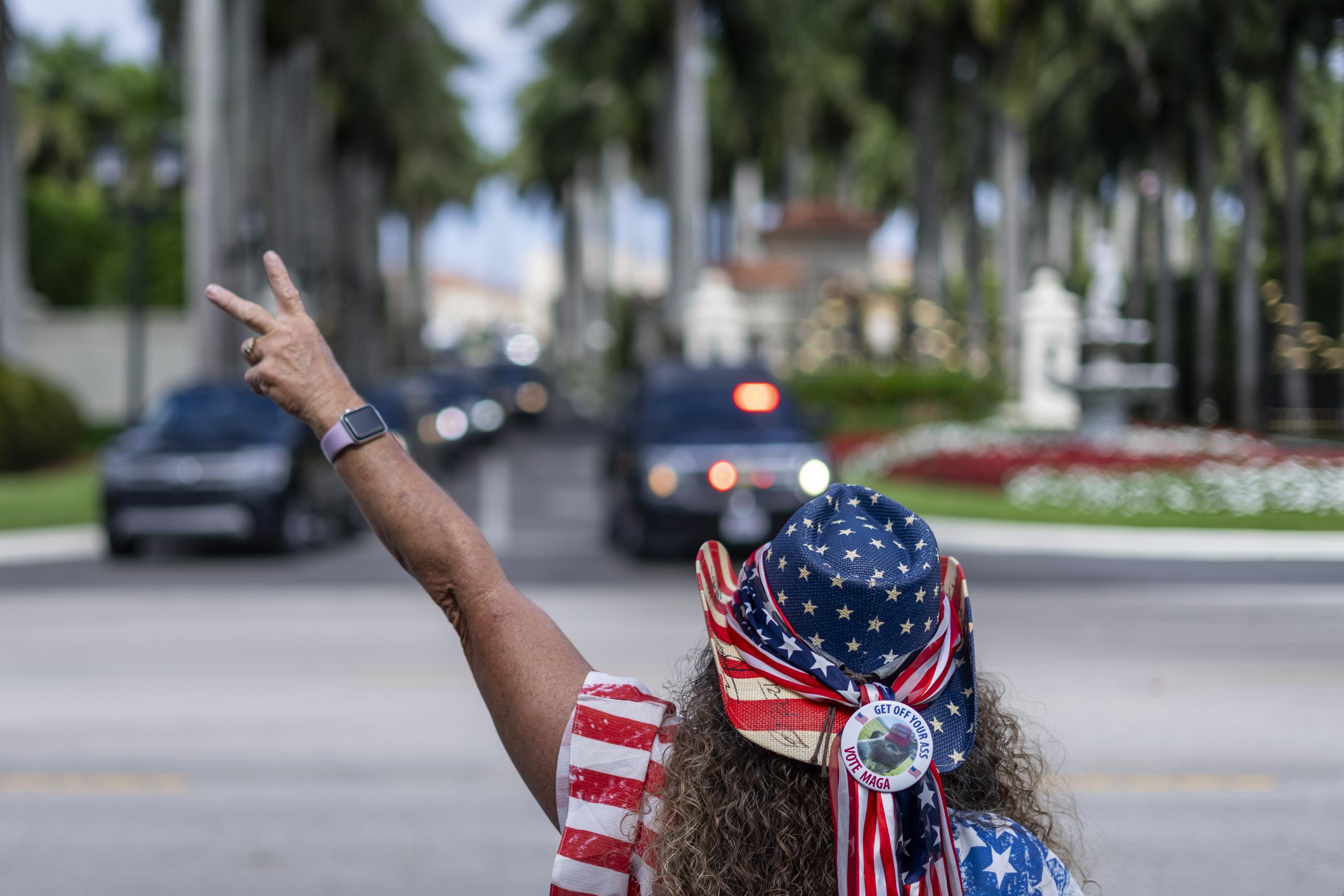 A supporter of President Trump gestures at a Presidents Day rally near the Trump International Golf Club in West Palm Beach, Fla., on Monday. (AP Photo/Ben Curtis)