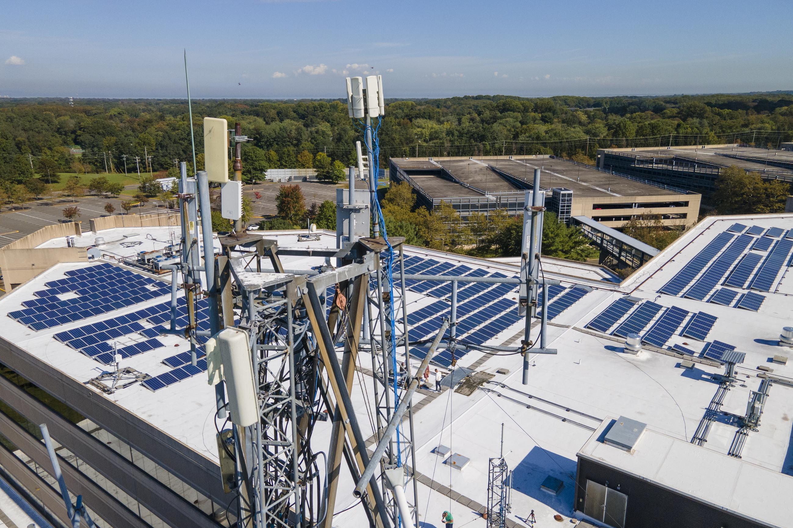 Solar panels and a cellular tower (AP Photo/Ted Shaffrey)