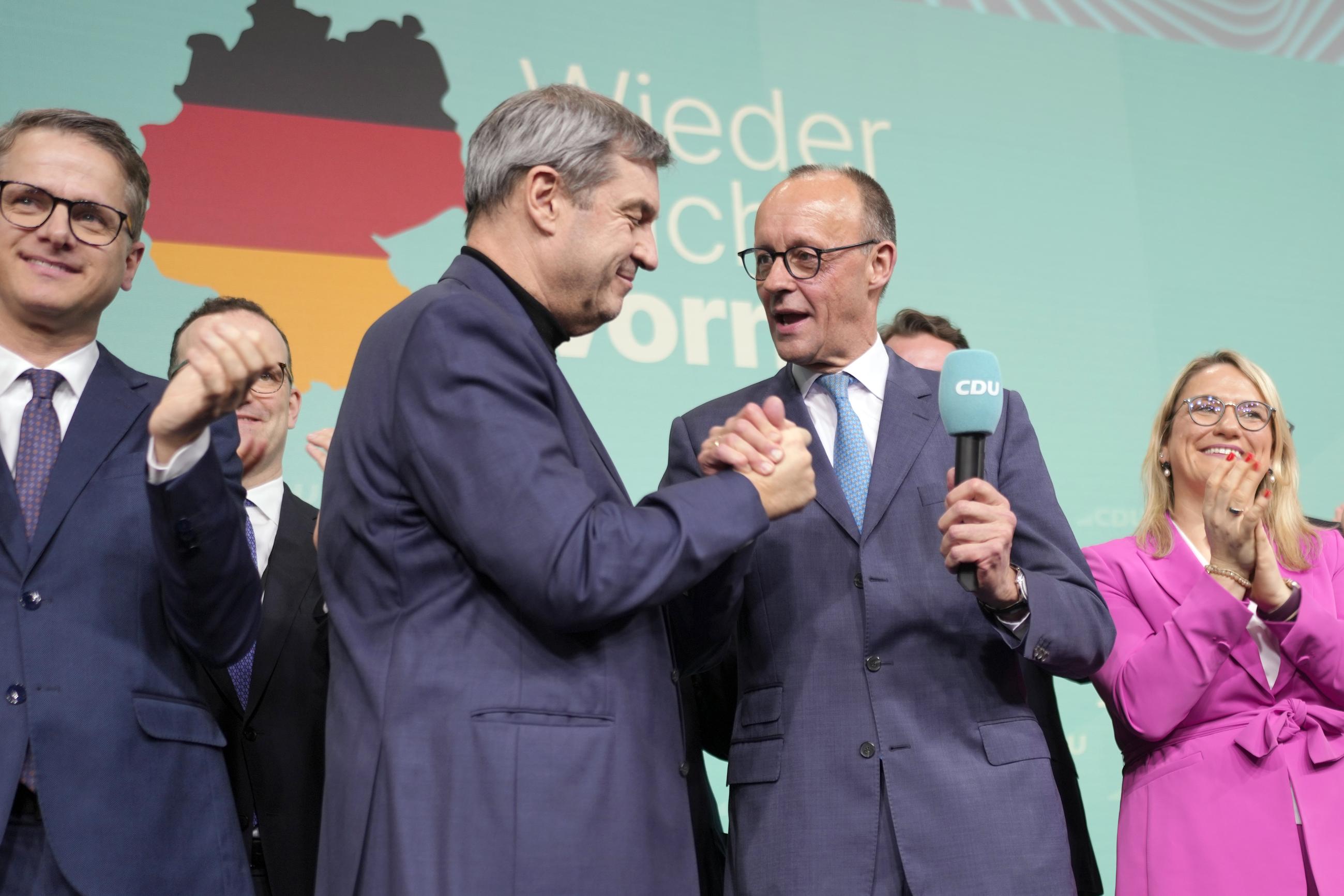 Friedrich Merz, with the microphone, in Berlin on Sunday after the German national election (AP Photo/Markus Schreiber)