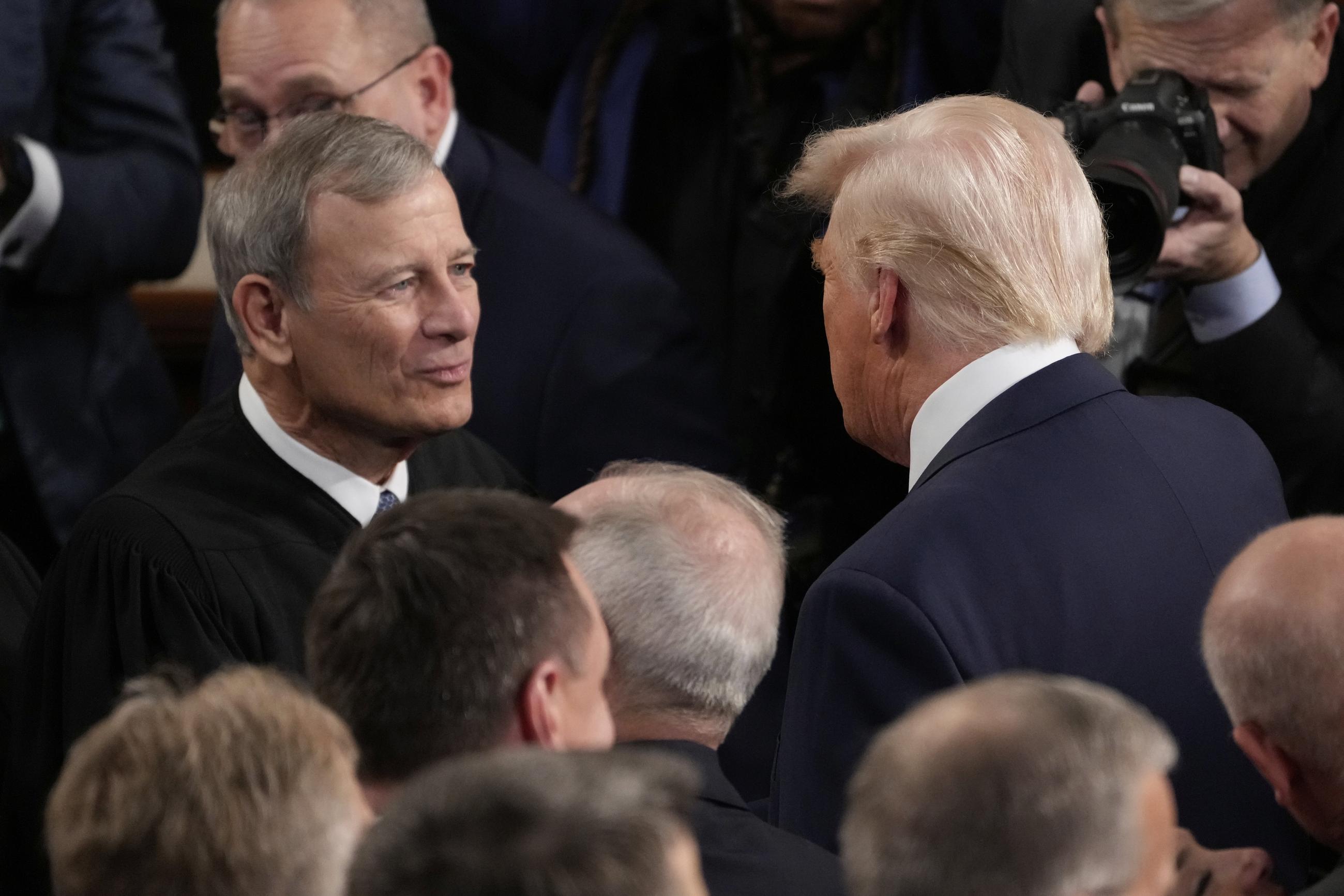 President Trump greets Chief Justice John Roberts before his address to a joint session of Congress on March 4. (AP Photo/Julia Demaree Nikhinson)