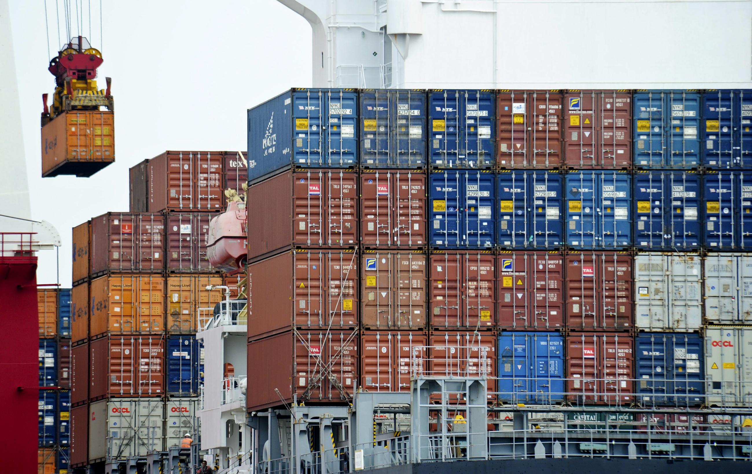 A container is loaded onto a cargo ship at the Tianjin port in China.