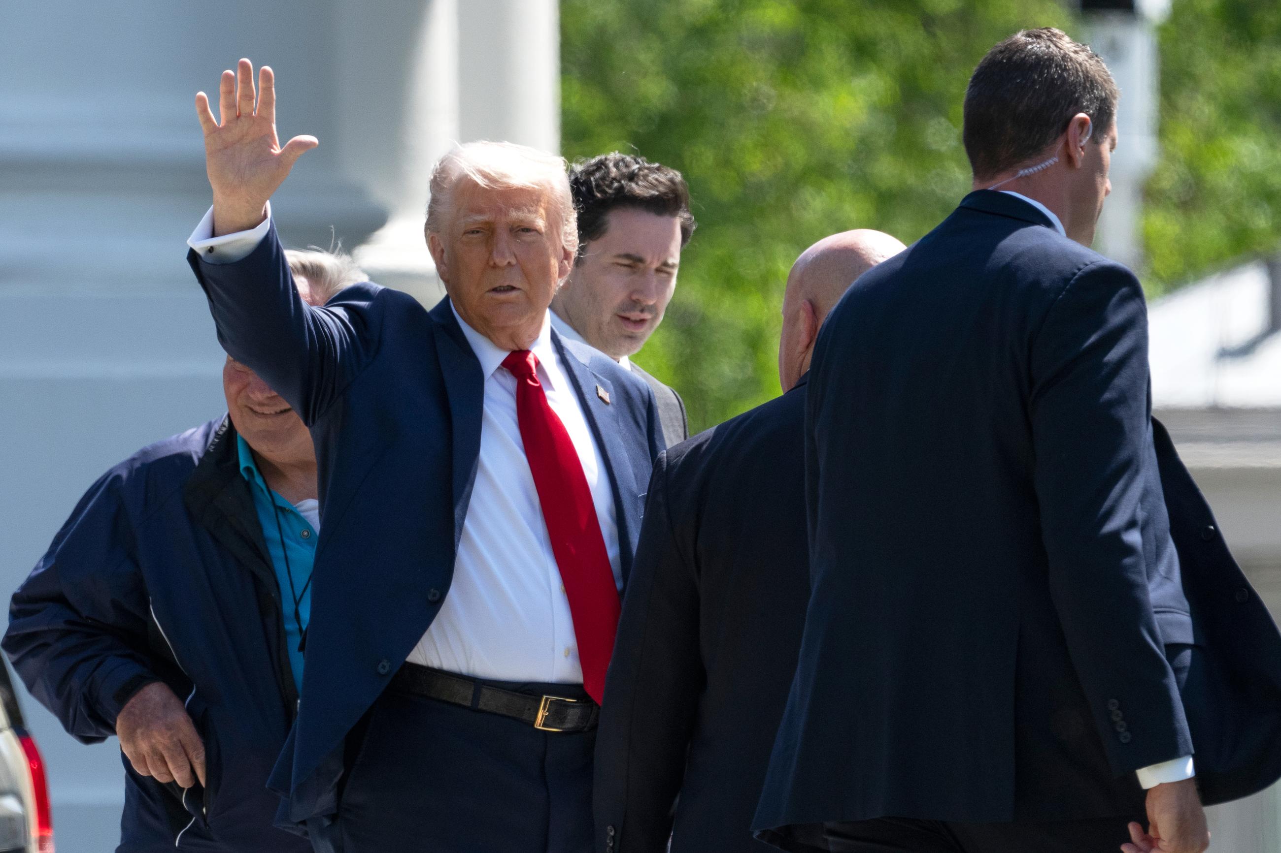 President Donald Trump waves as he walks towards the White House from the North Lawn in Washington, Wednesday, April 23, 2025, in Washington. (AP Photo/Mark Schiefelbein)