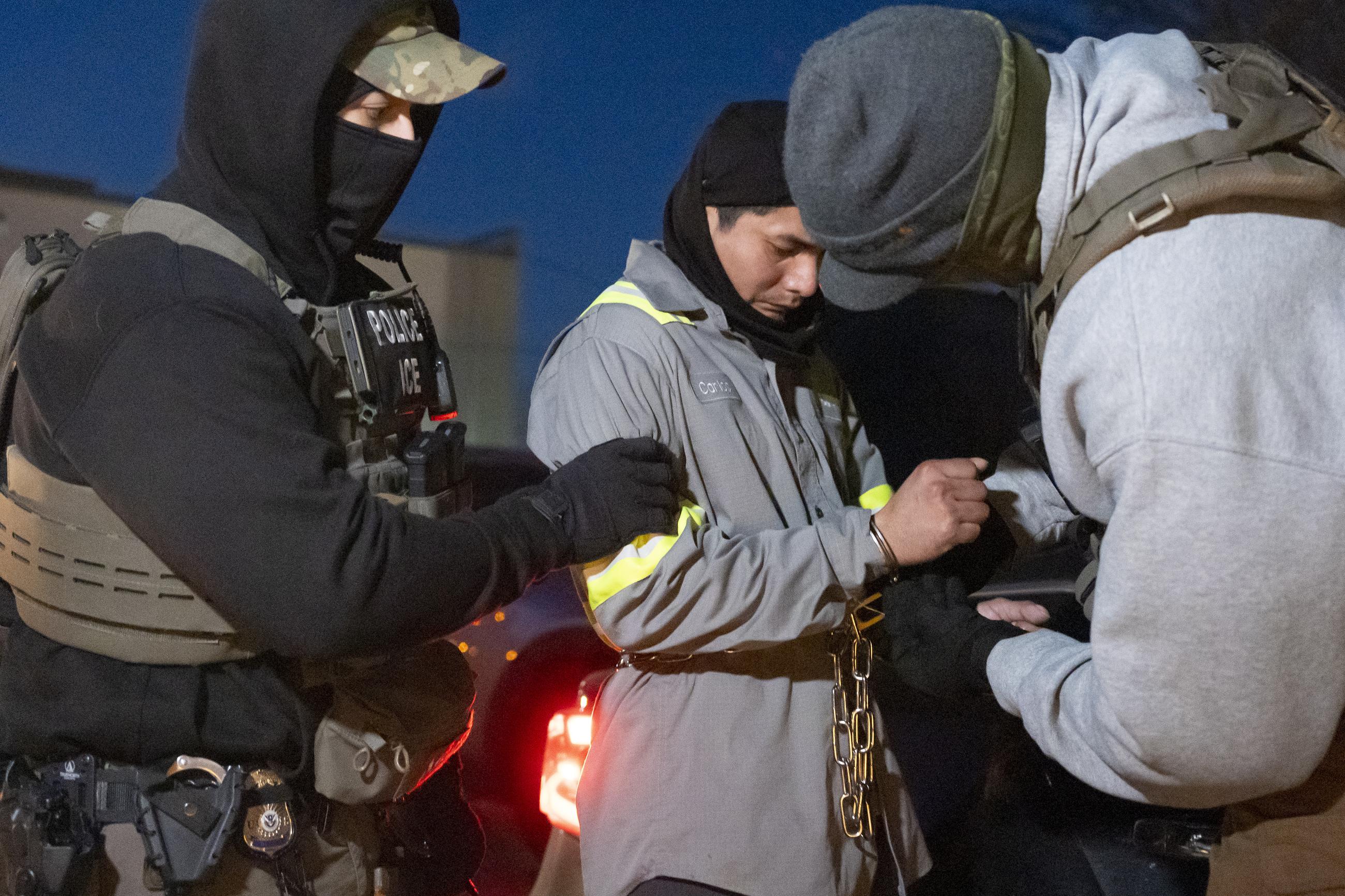 U.S. Immigration and Customs Enforcement officers detain a person on Jan. 27 in Silver Spring, Md. (AP Photo/Alex Brandon)