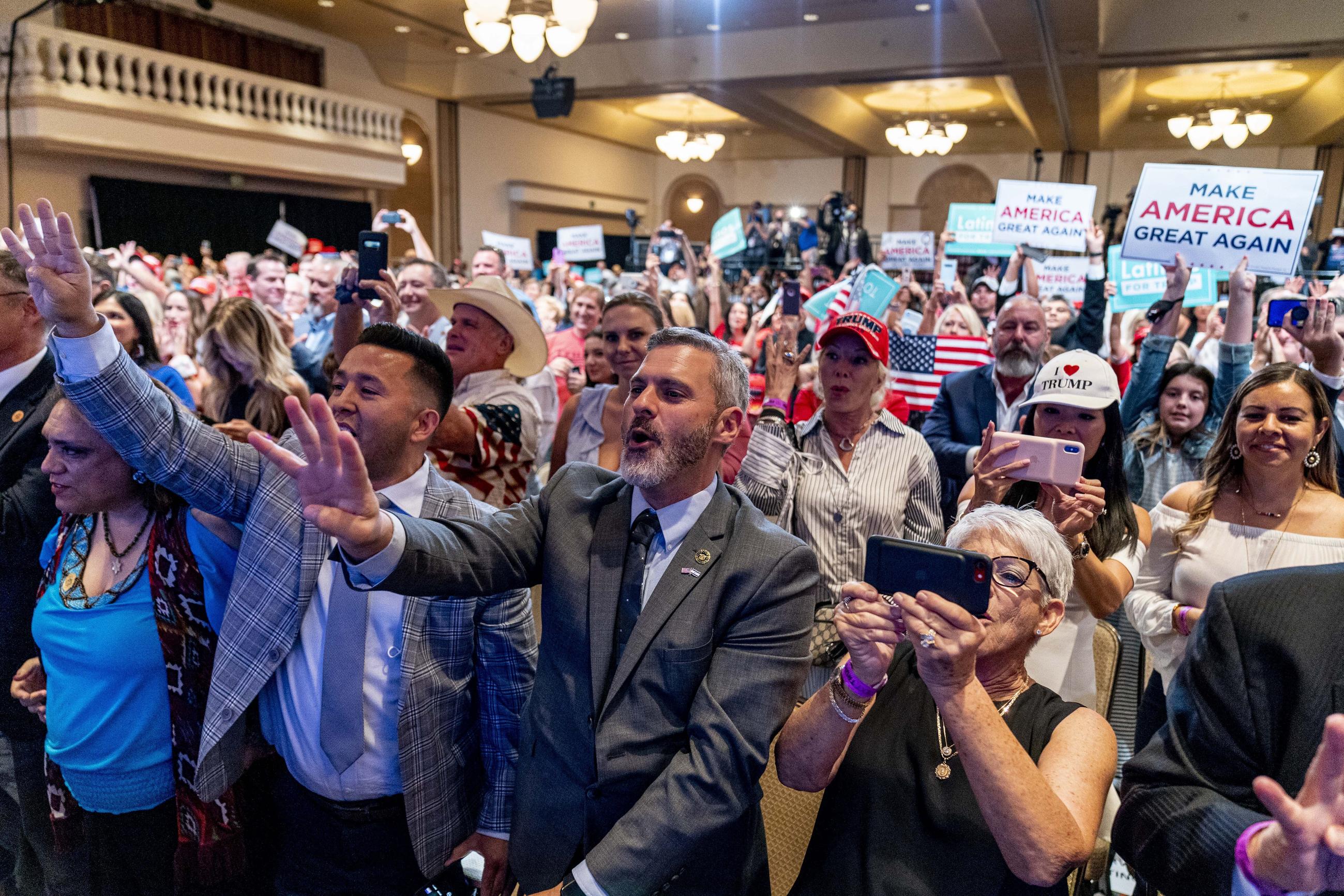Supporters react as President Trump speaks at a Latinos for Trump Coalition roundtable in Phoenix in September 2020.  (AP Photo/Andrew Harnik)