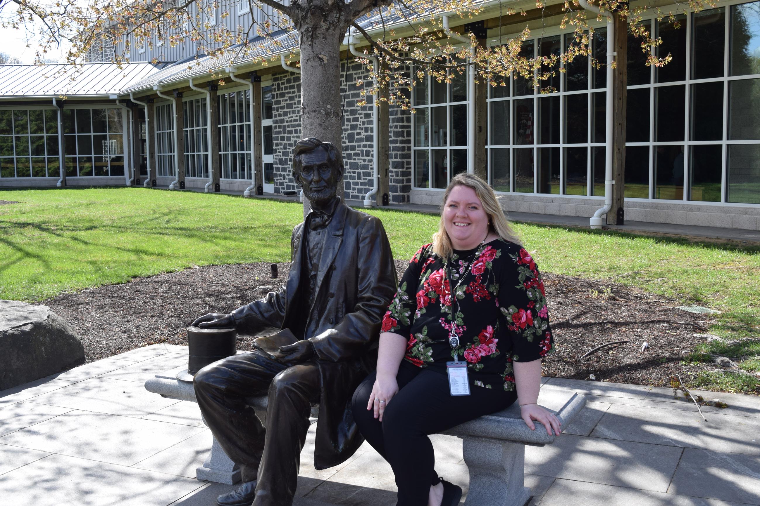 Jackie Spainhour, president of the Gettysburg Foundation, next to a statue of Abraham Lincoln outside the Gettysburg museum