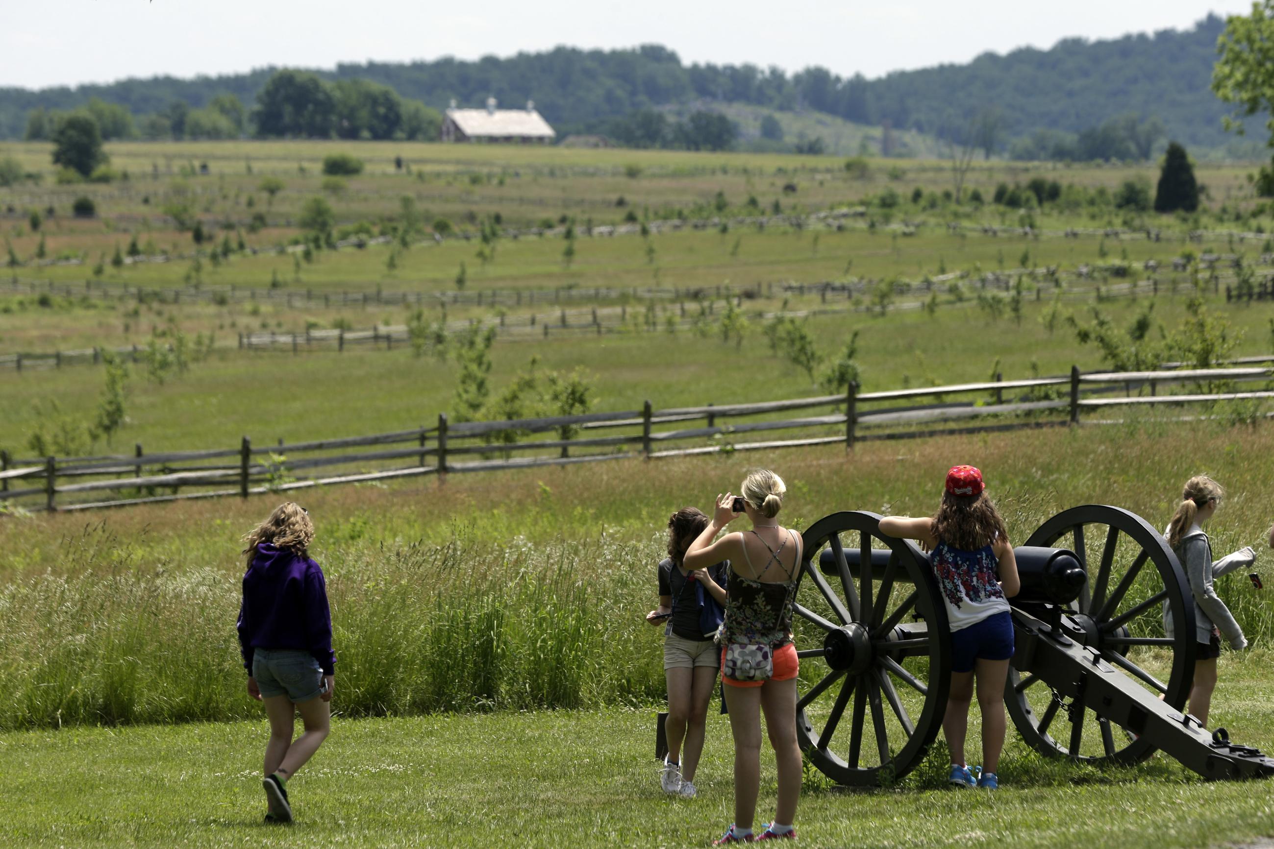 In this 2013 file photo, tourists gather near a Confederate artillery piece that sits atop a ridge above the field of Pickett's Charge in Gettysburg. (Associated Press)