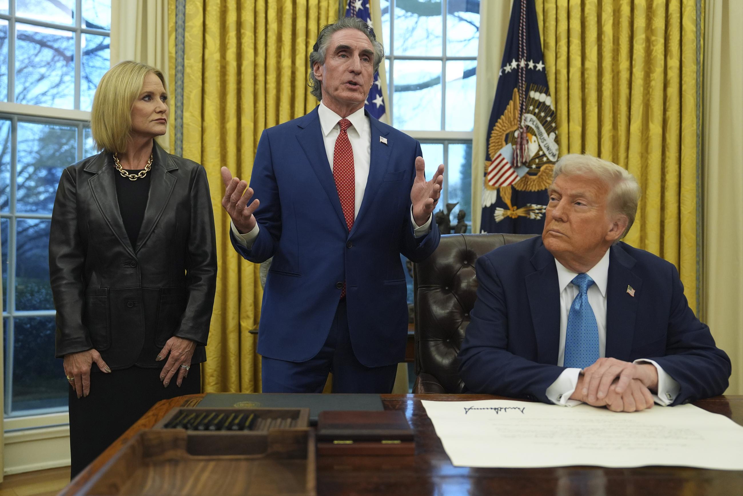 Interior Secretary Doug Burgum with his wife, Kathryn, and President Trump in the Oval Office in January (AP Photo/Evan Vucci,File)
