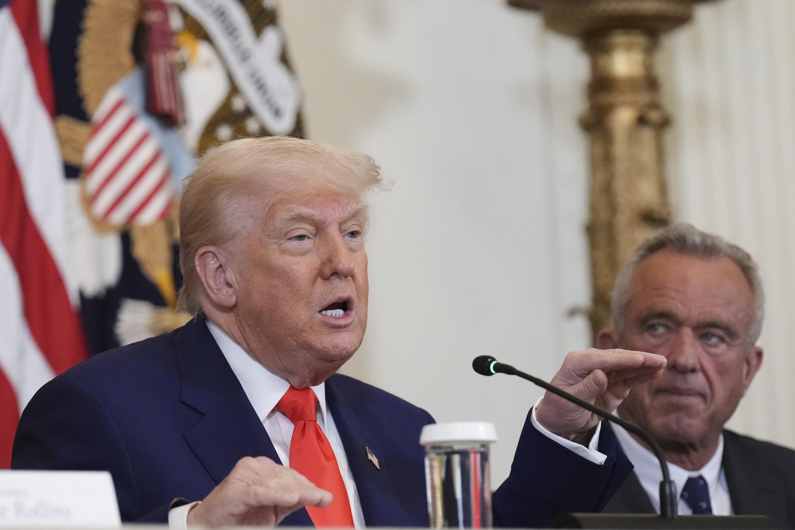 President Donald Trump, left, speaks as Health and Human Services Secretary Robert F. Kennedy Jr. listens during a Make America Healthy Again (MAHA) Commission Event in the East Room of the White House, Thursday, May 22, 2025, in Washington. (AP Photo/Jacquelyn Martin)
