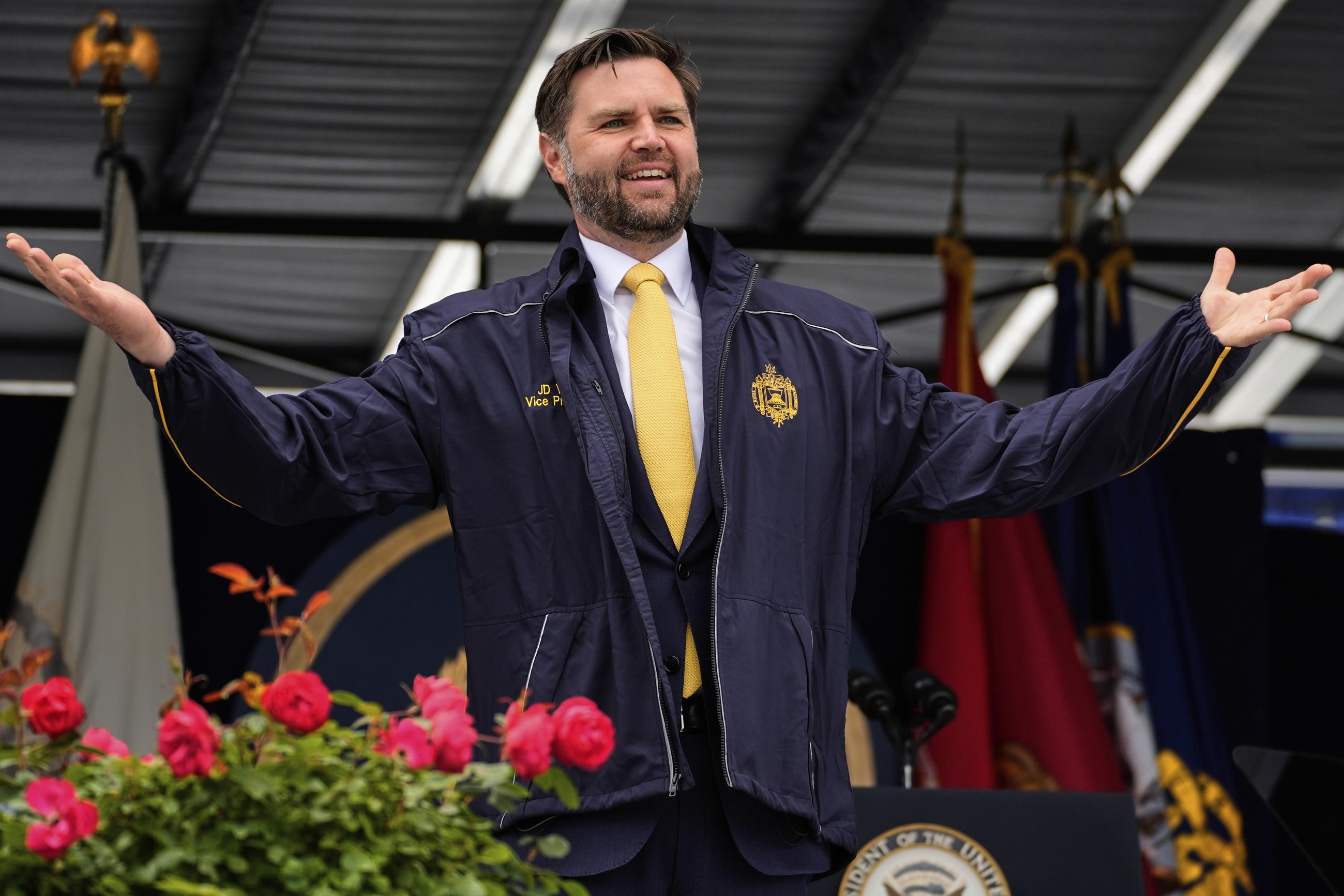 Vice President J.D. Vance displays a U.S. Naval Academy jacket he received during the Academy's graduation and commissioning ceremony in Annapolis, Md., on Friday. (AP Photo/Stephanie Scarbrough)